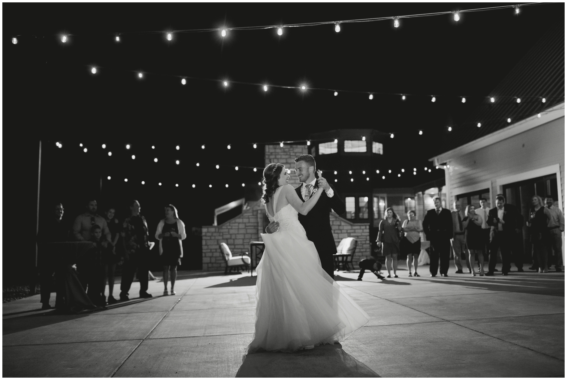 First dance outdoors under market lights at Flying Horse Ranch Colorado wedding 