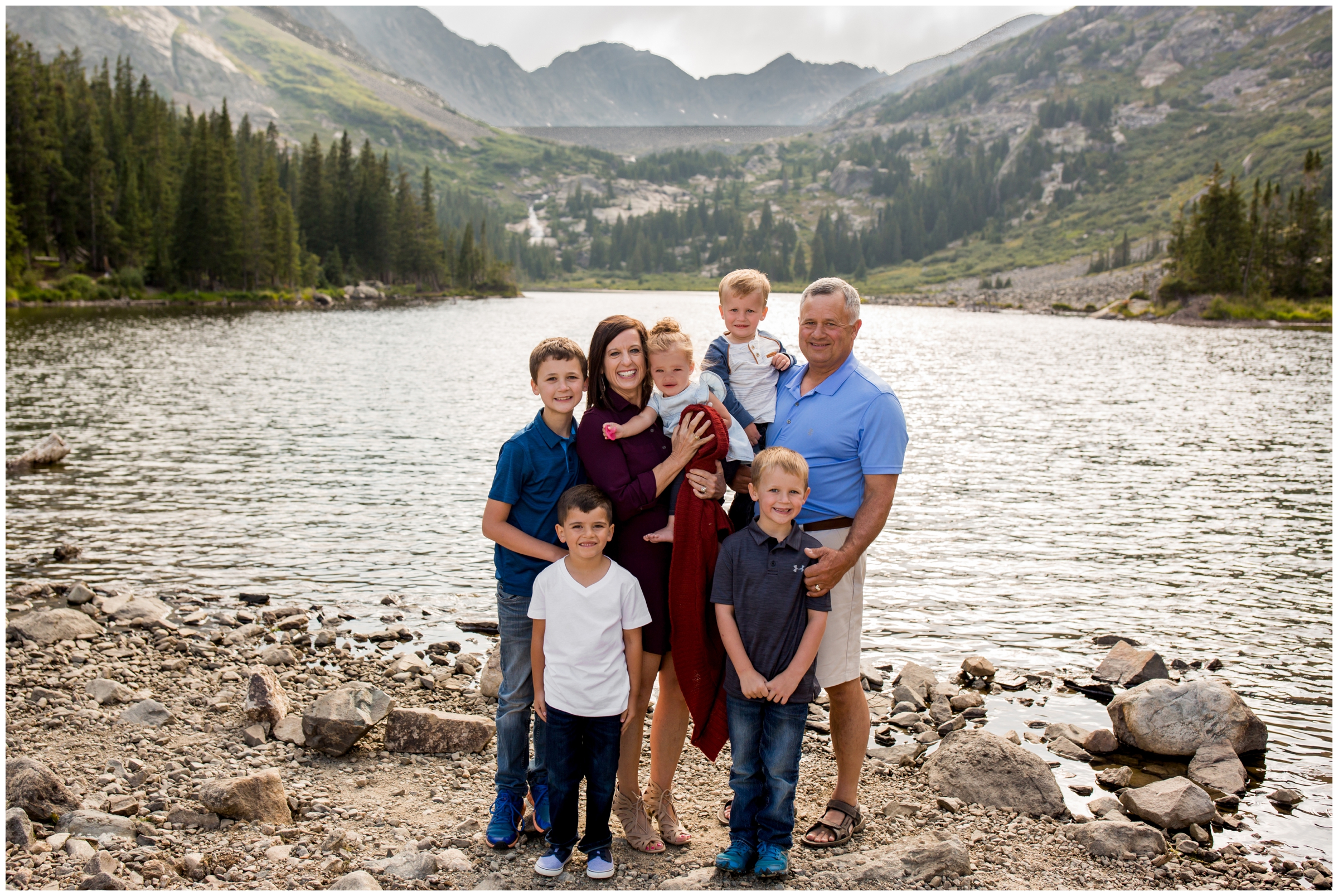 grandparents and all their grandkids standing in front of a lake at Breckenridge Colorado family photography session 