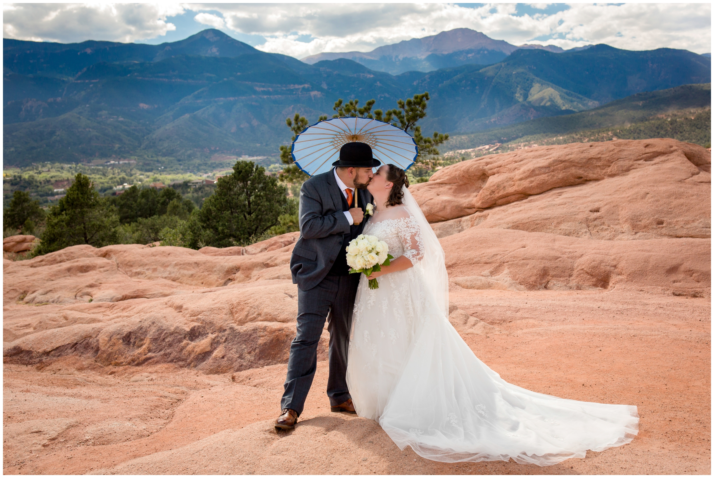 bride and groom with parasol during Garden of the Gods Colorado Springs wedding portraits