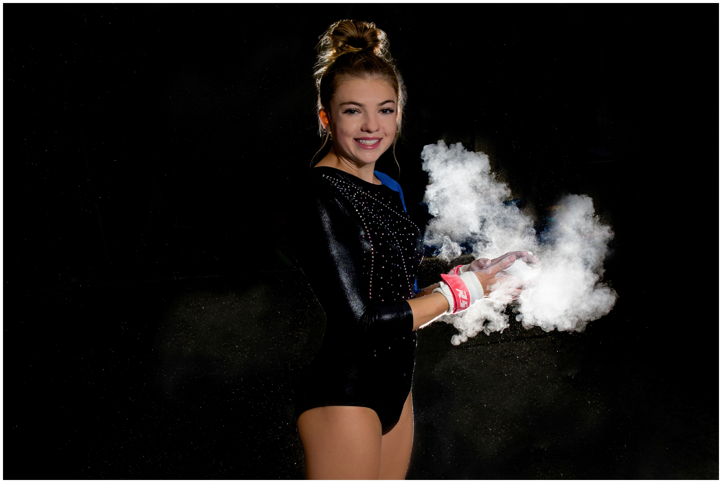 teen girl with chalk from uneven bars on hands during Gymnastics senior pictures by Colorado portrait photographer Plum Pretty Photography