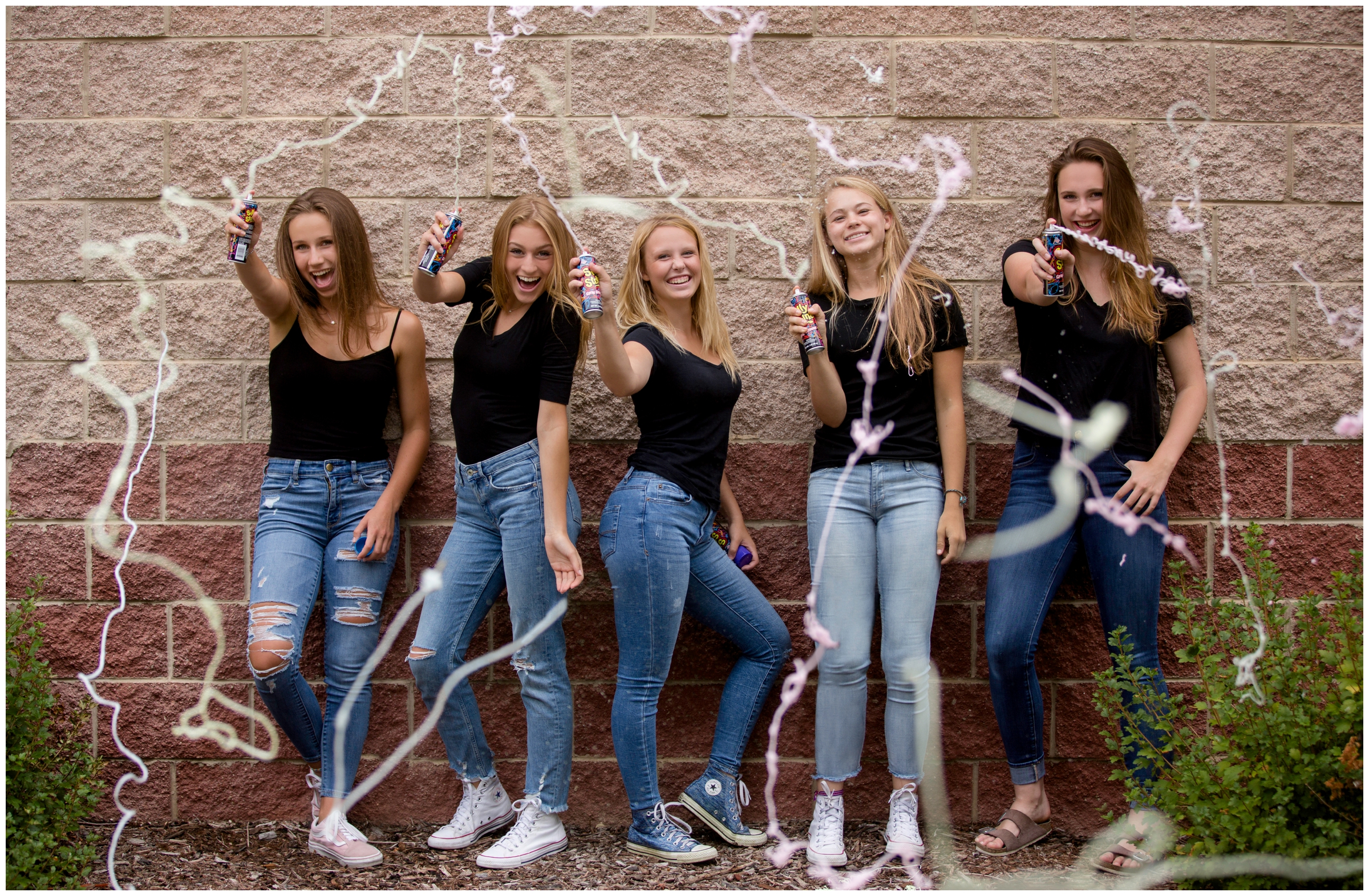 teens spraying silly string at group Longmont Colorado senior photos 