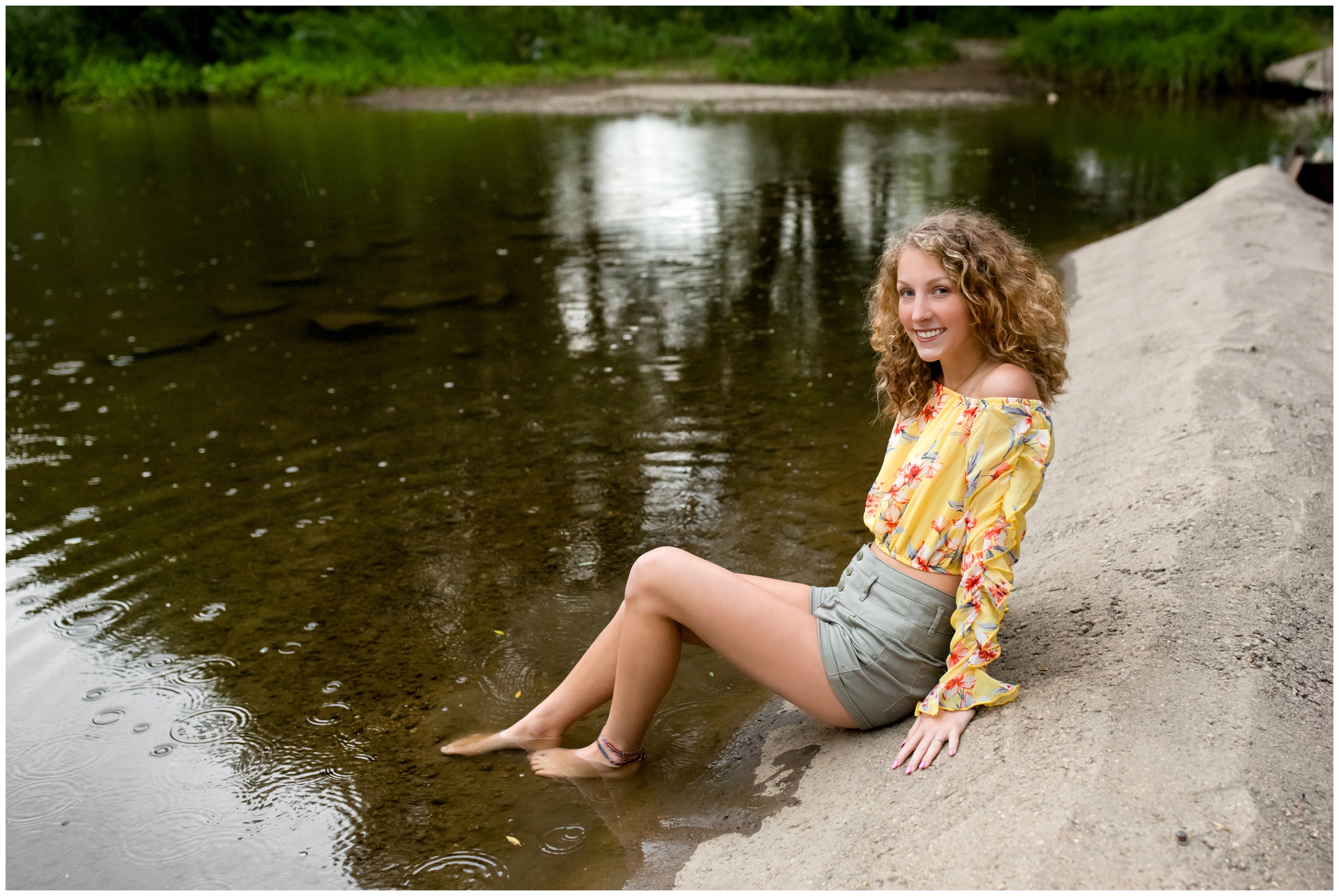 teenager barefoot in lake during Mead Colorado senior pictures 