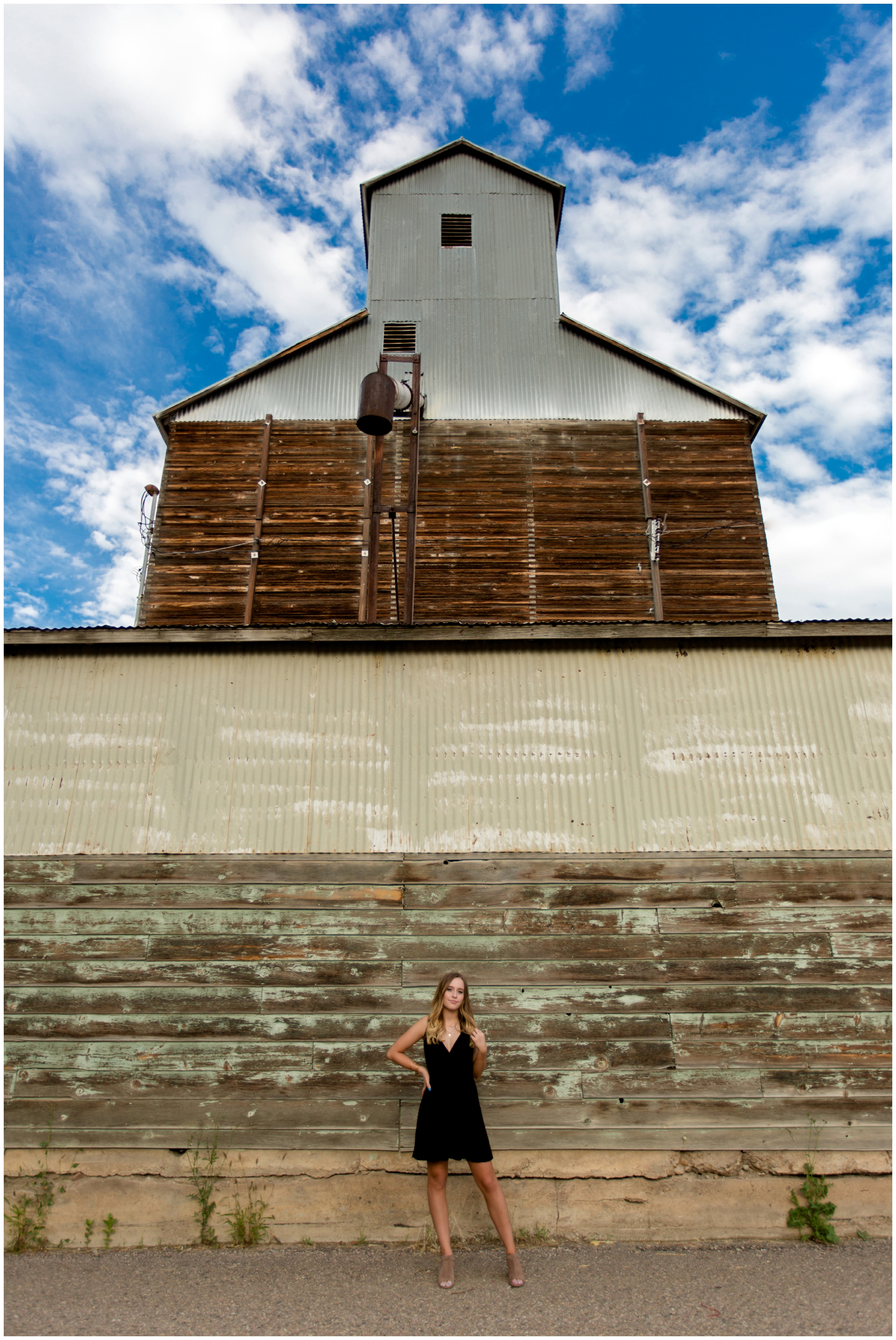 skyline high school student posing at grain mill for Colorado senior pictures 
