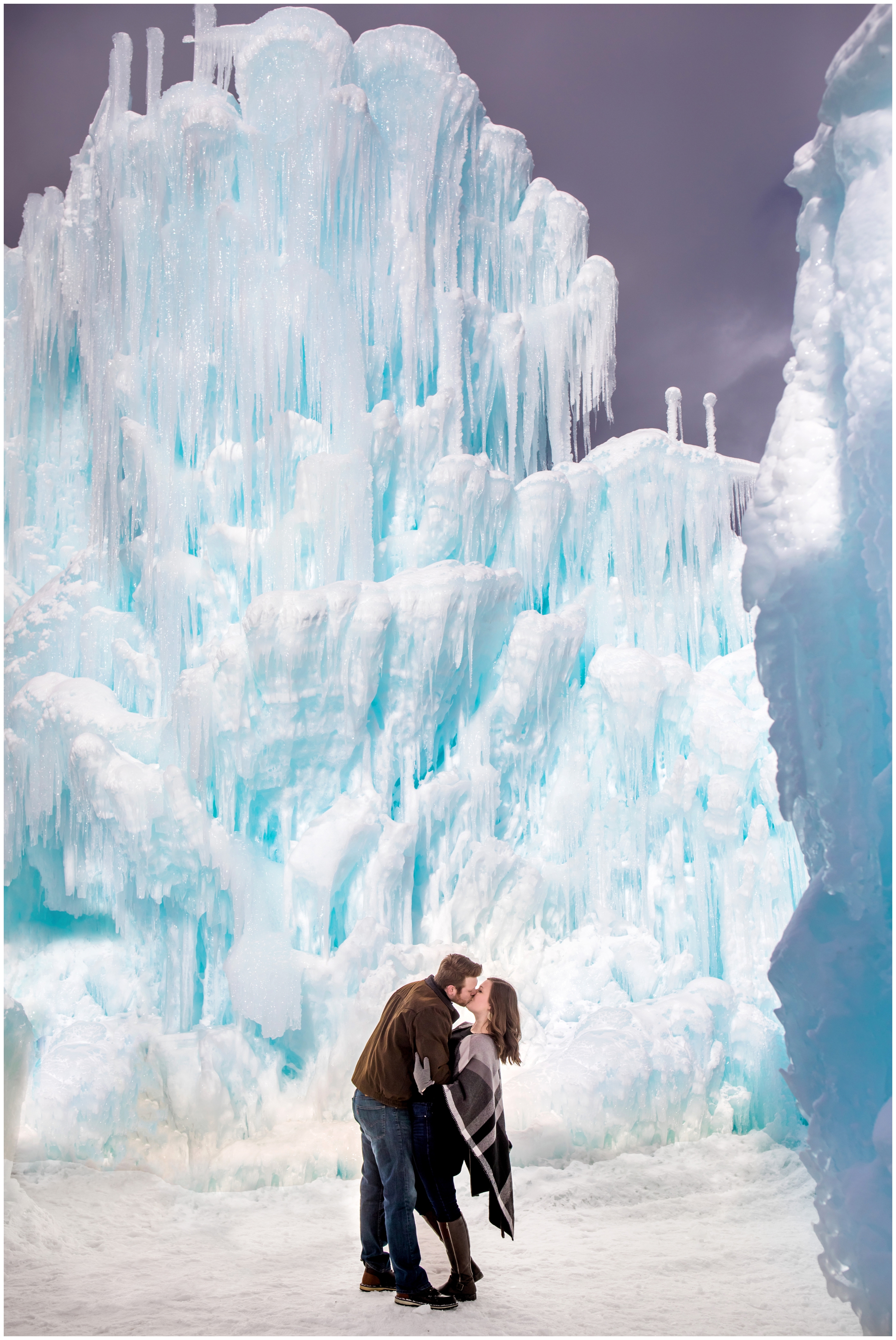 couple kissing during Breckenridge winter engagement photos at Dillon Ice Castles by Colorado wedding photographer Plum Pretty Photography
