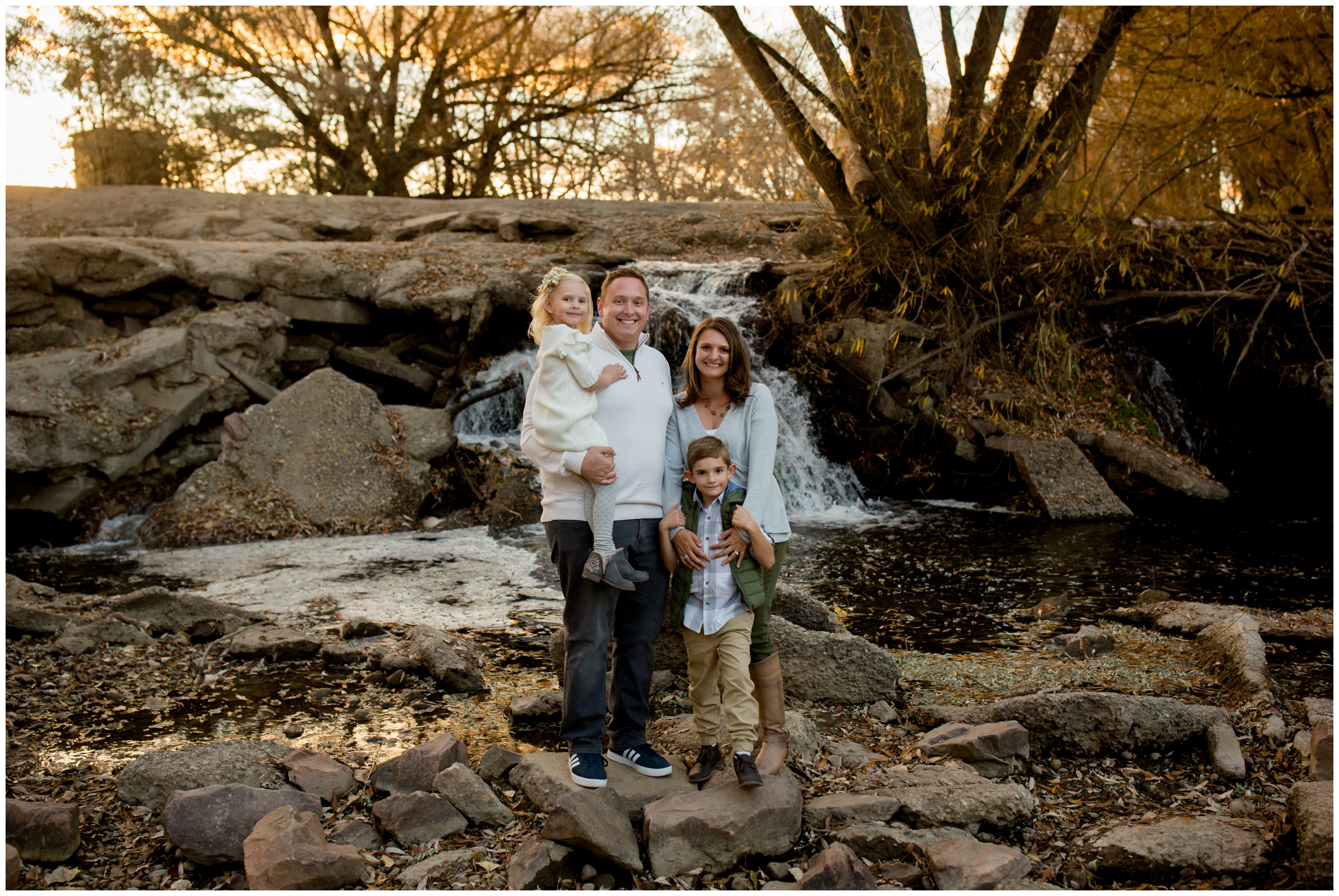 family posing in front of waterfall at Longmont colorado fall family pictures