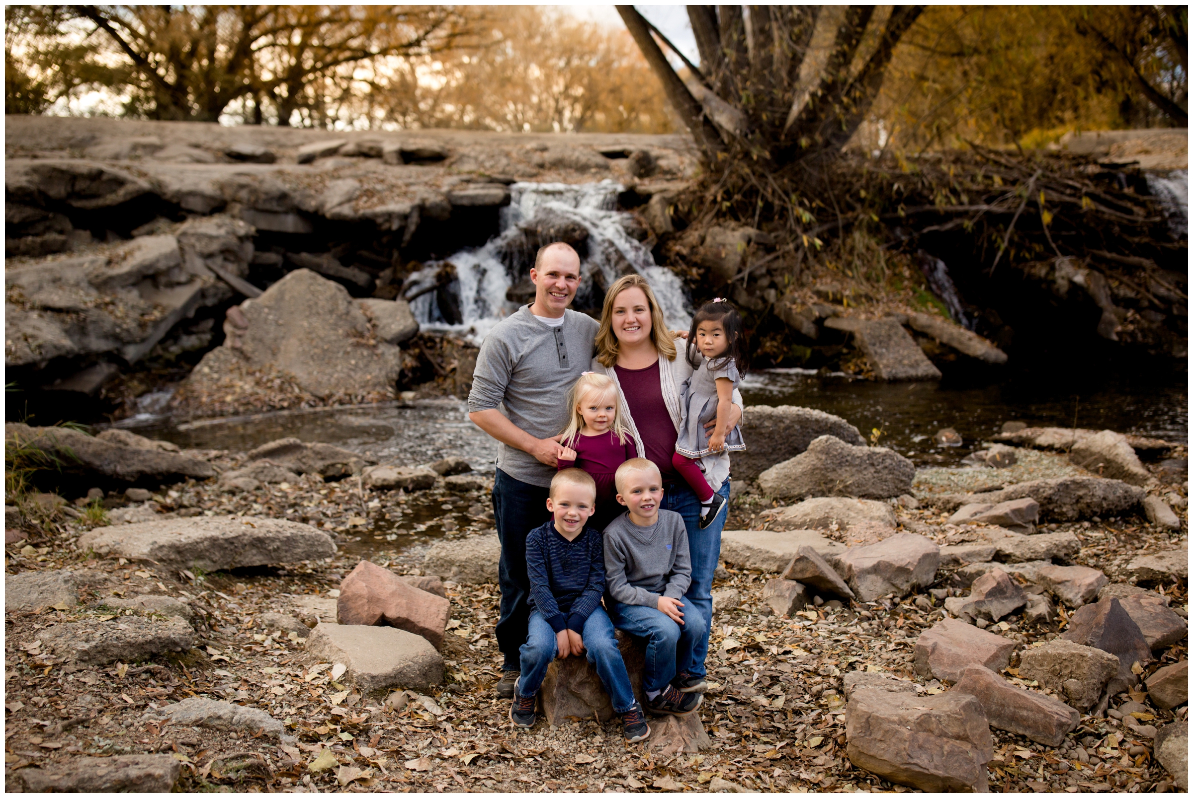 family standing in front of waterfall during Longmont Colorado family photos 