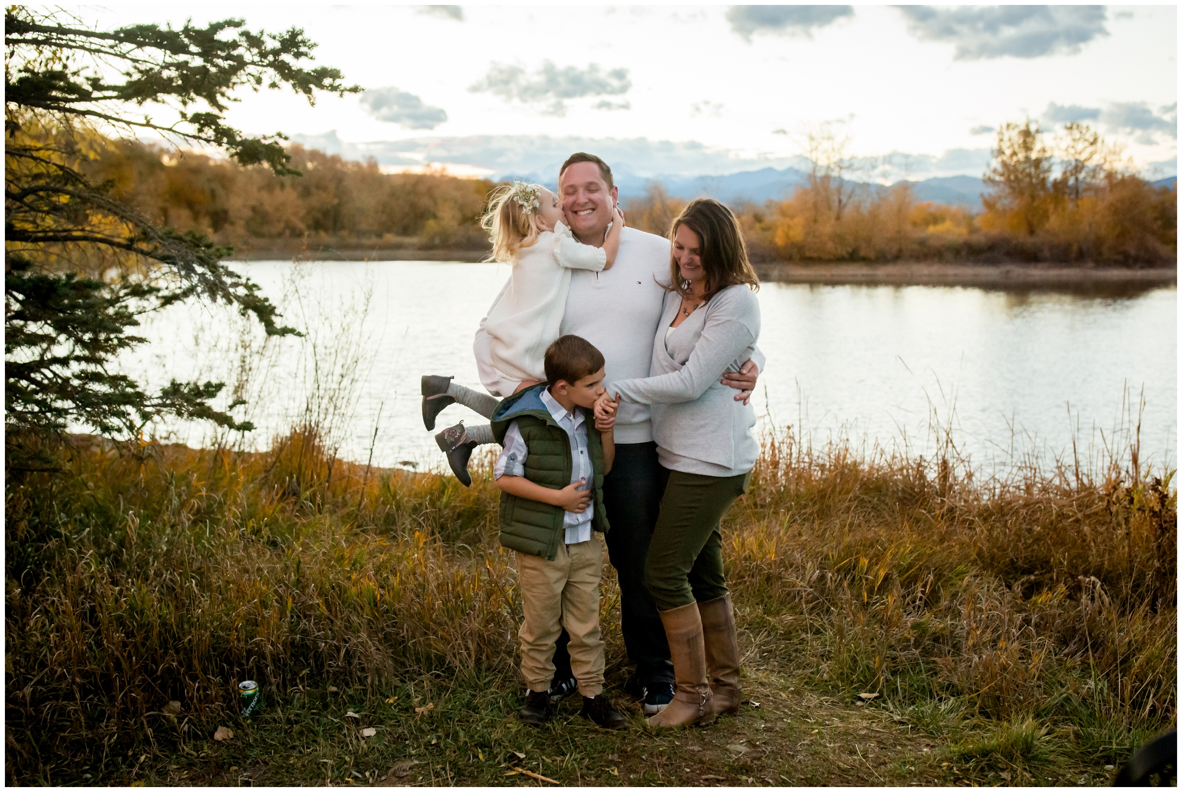 family standing in front of lake at Golden Ponds Nature Area Longmont