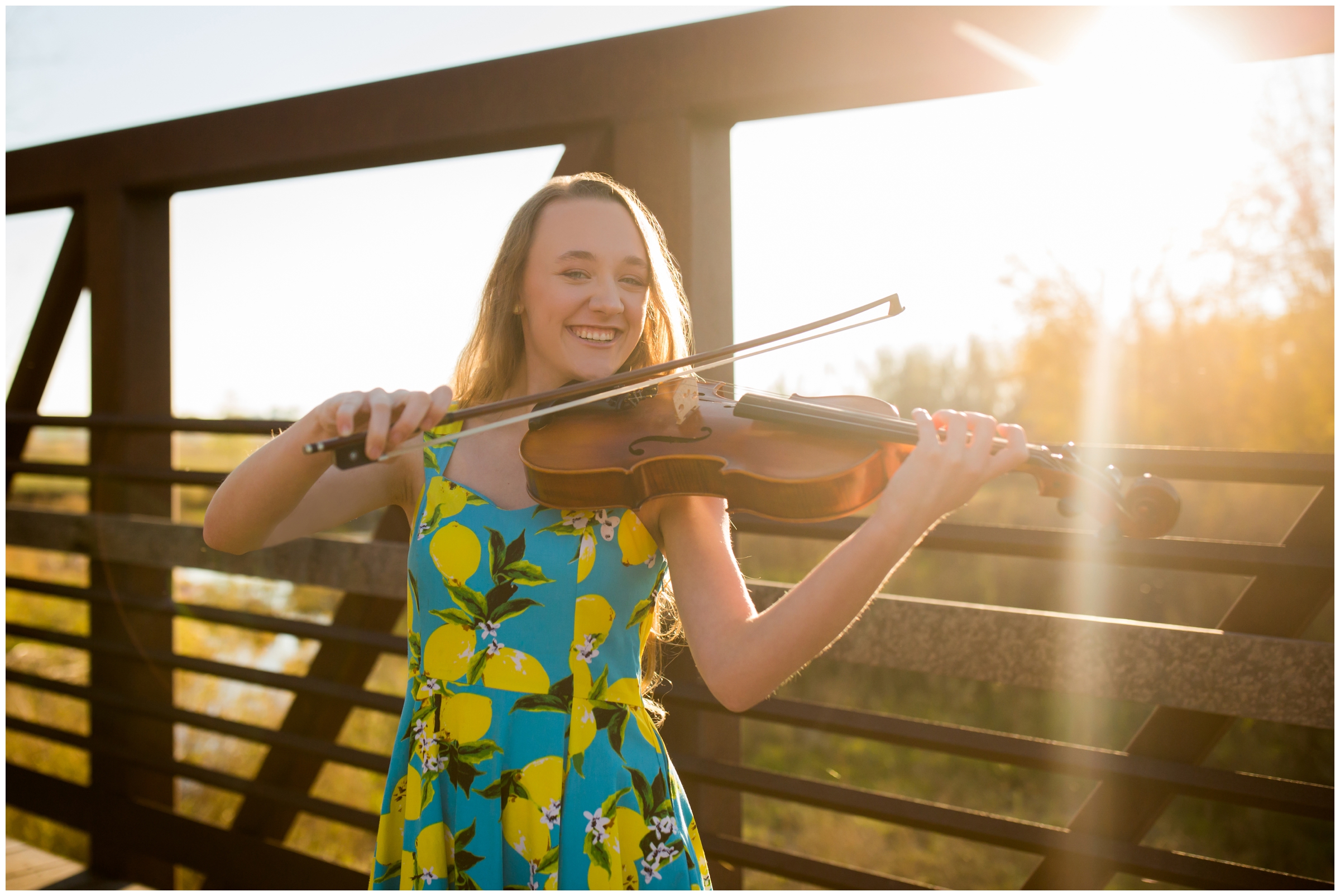 teen girl playing viola during Longmont CO senior pictures at Sandstone Ranch Colorado