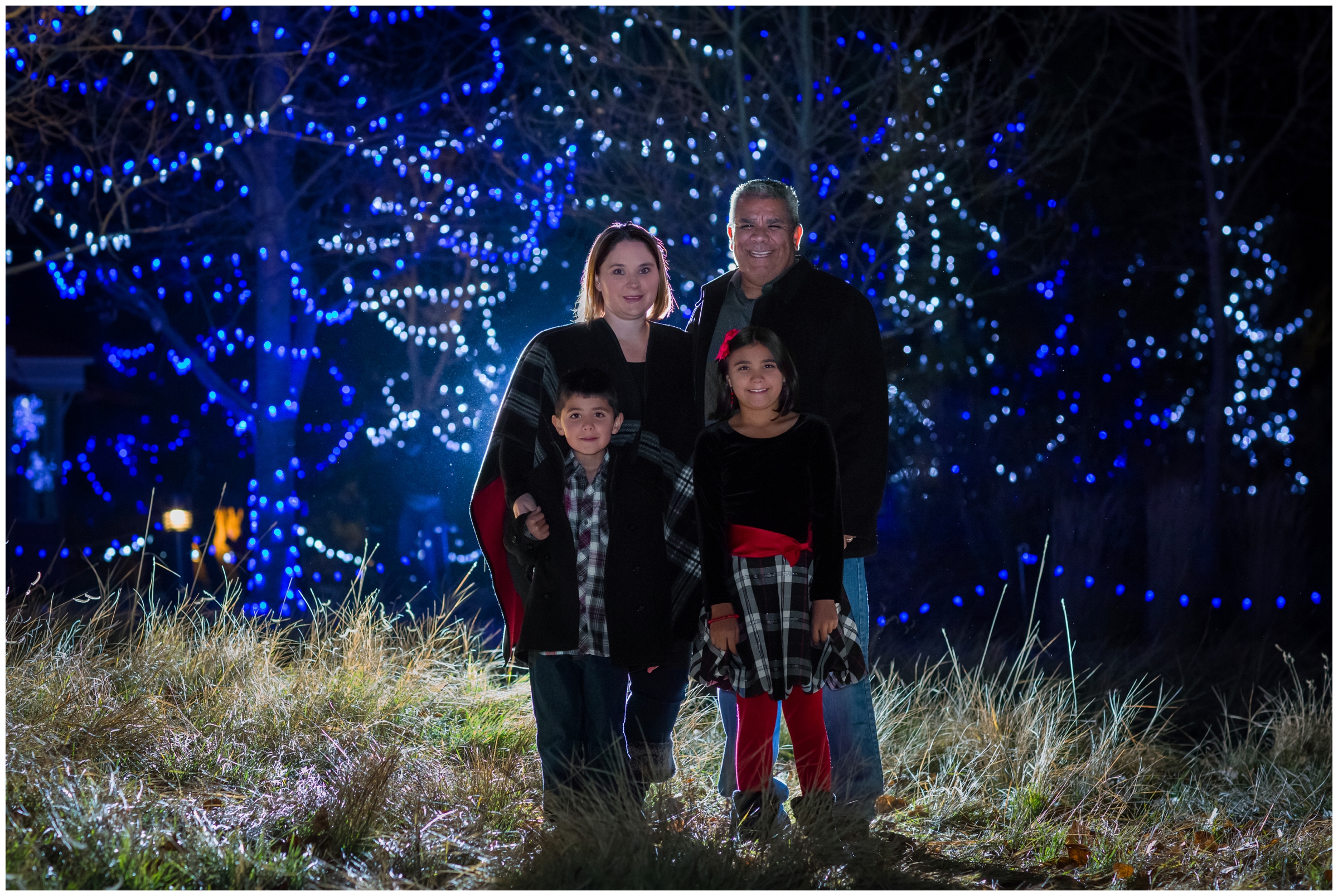 nighttime Loveland Colorado family pictures at Winter Wonderlights at Chapungu Sculpture Gardens