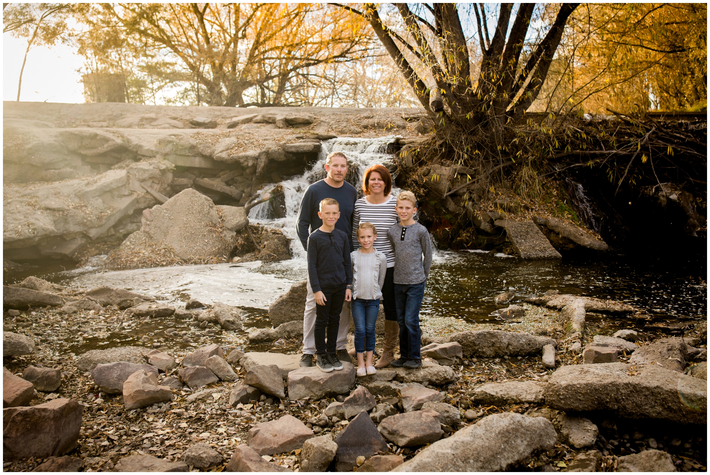 Fall Longmont Colorado family pictures by a waterfall at Golden Ponds