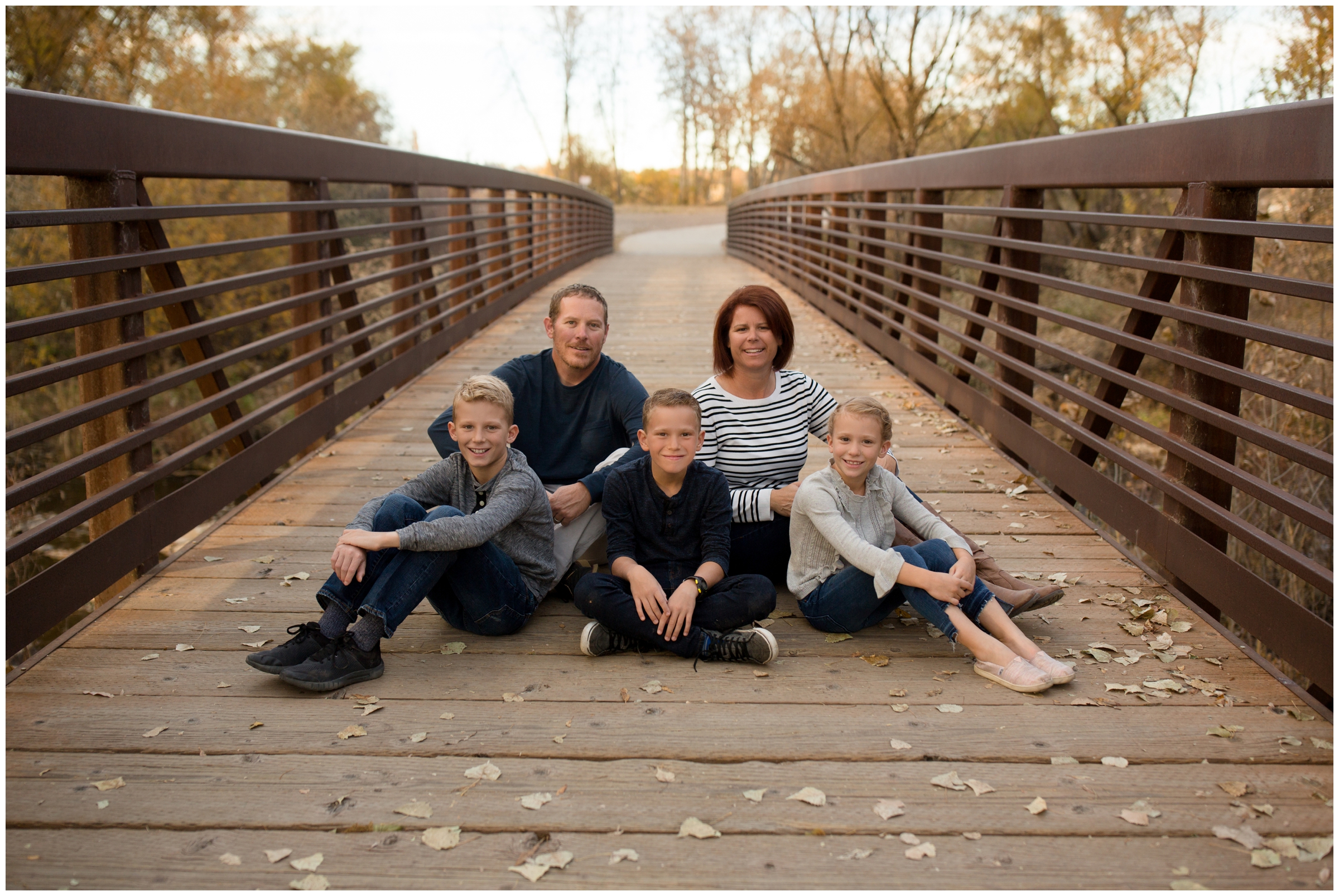 Boulder County family photos on a bridge at Golden Ponds by Longmont Colorado portrait photographer Plum Pretty Photography