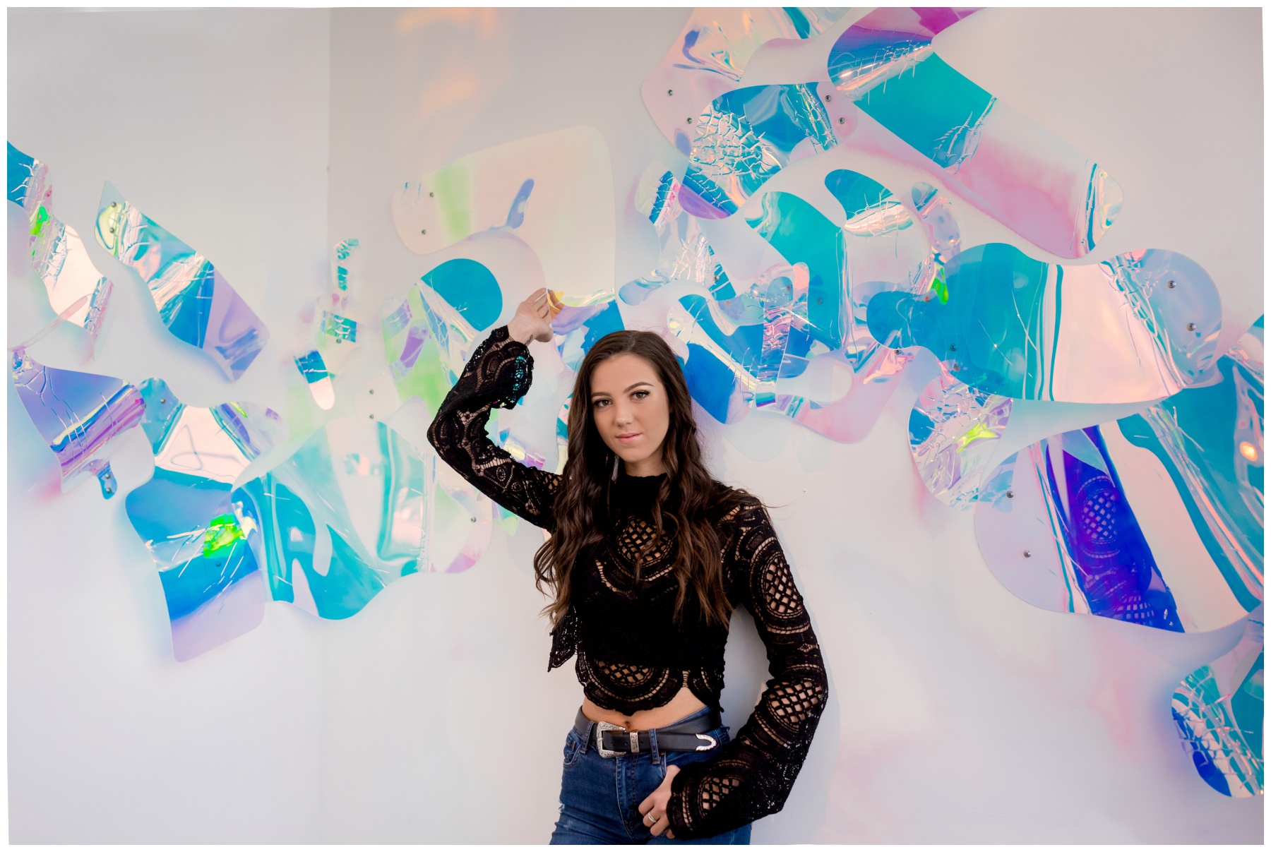 teen girl posing in front of colorful art installation at Wonder Wonder during Boulder Colorado senior pictures