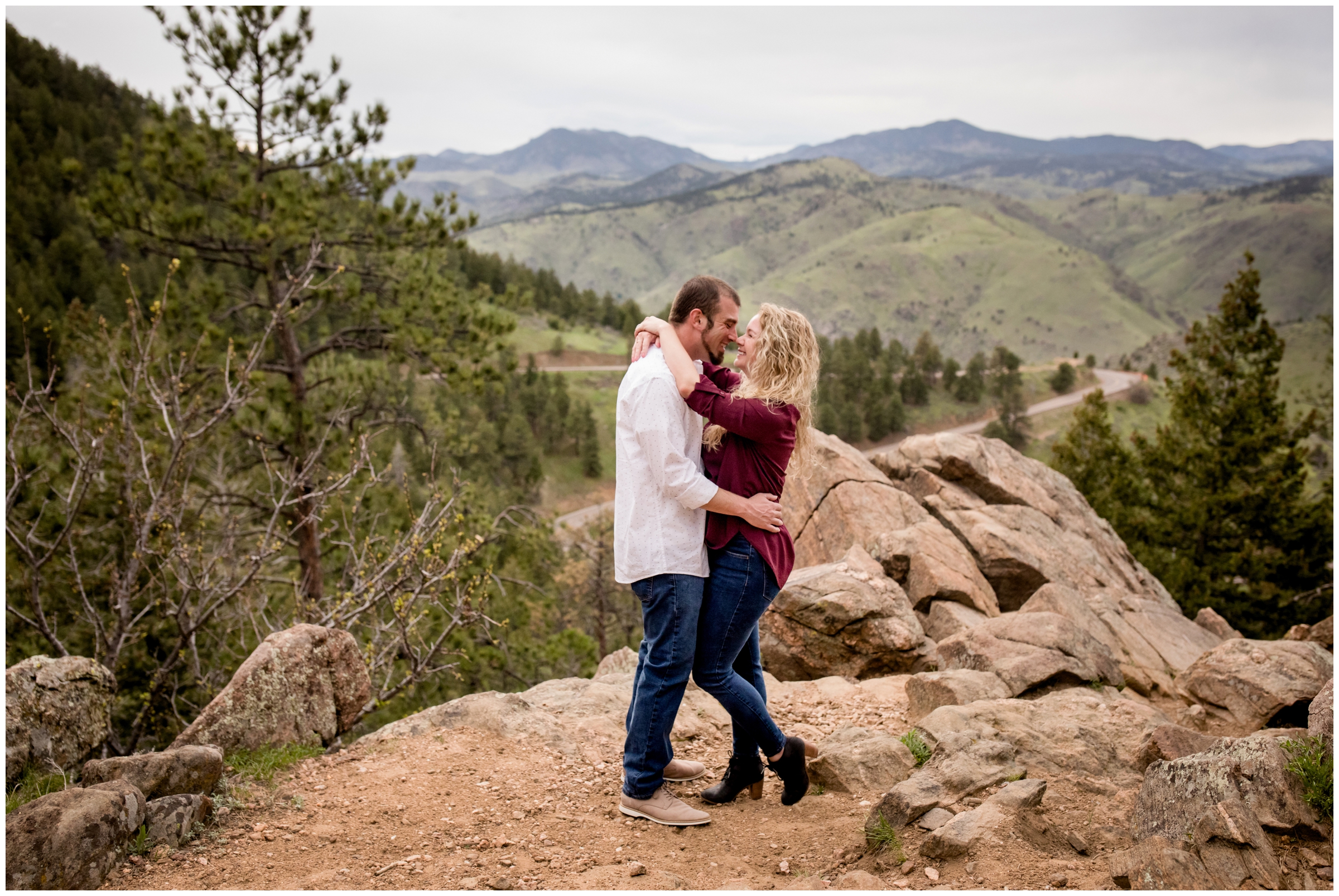 couple standing on mountaintop during Lookout Mountain Colorado engagement photos 