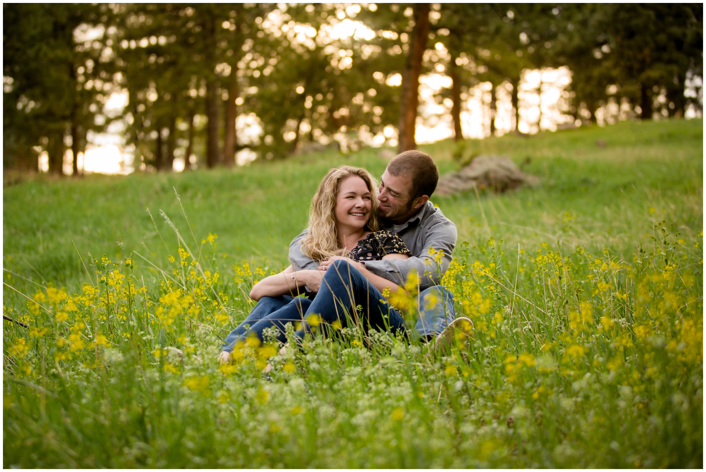 couple sitting in field of wildflowers during their Lookout Mountain engagement photography by Golden Colorado portrait photographer Plum Pretty Photography