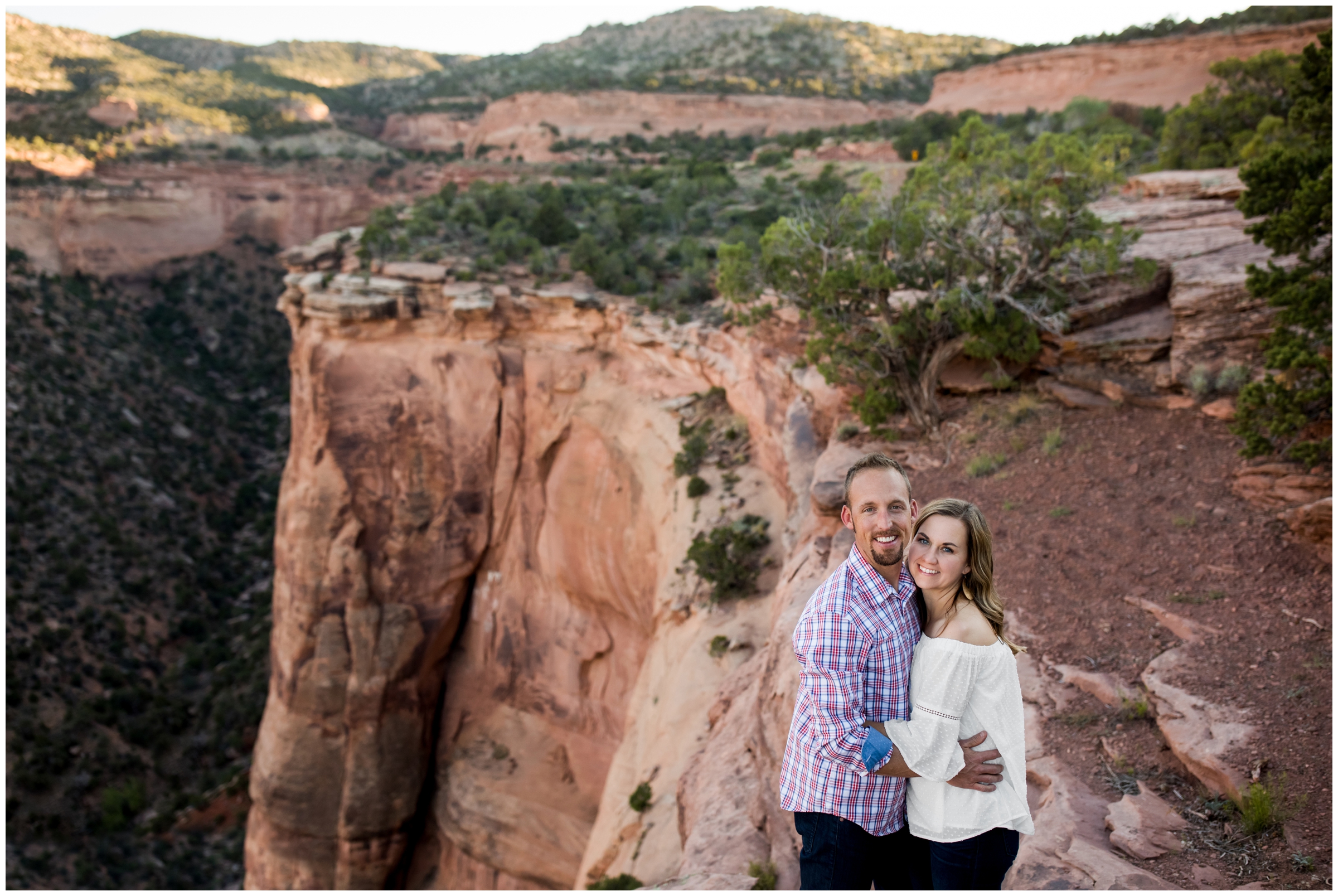 couple standing on a cliff during Grand Junction engagement portraits at Colorado National Monument
