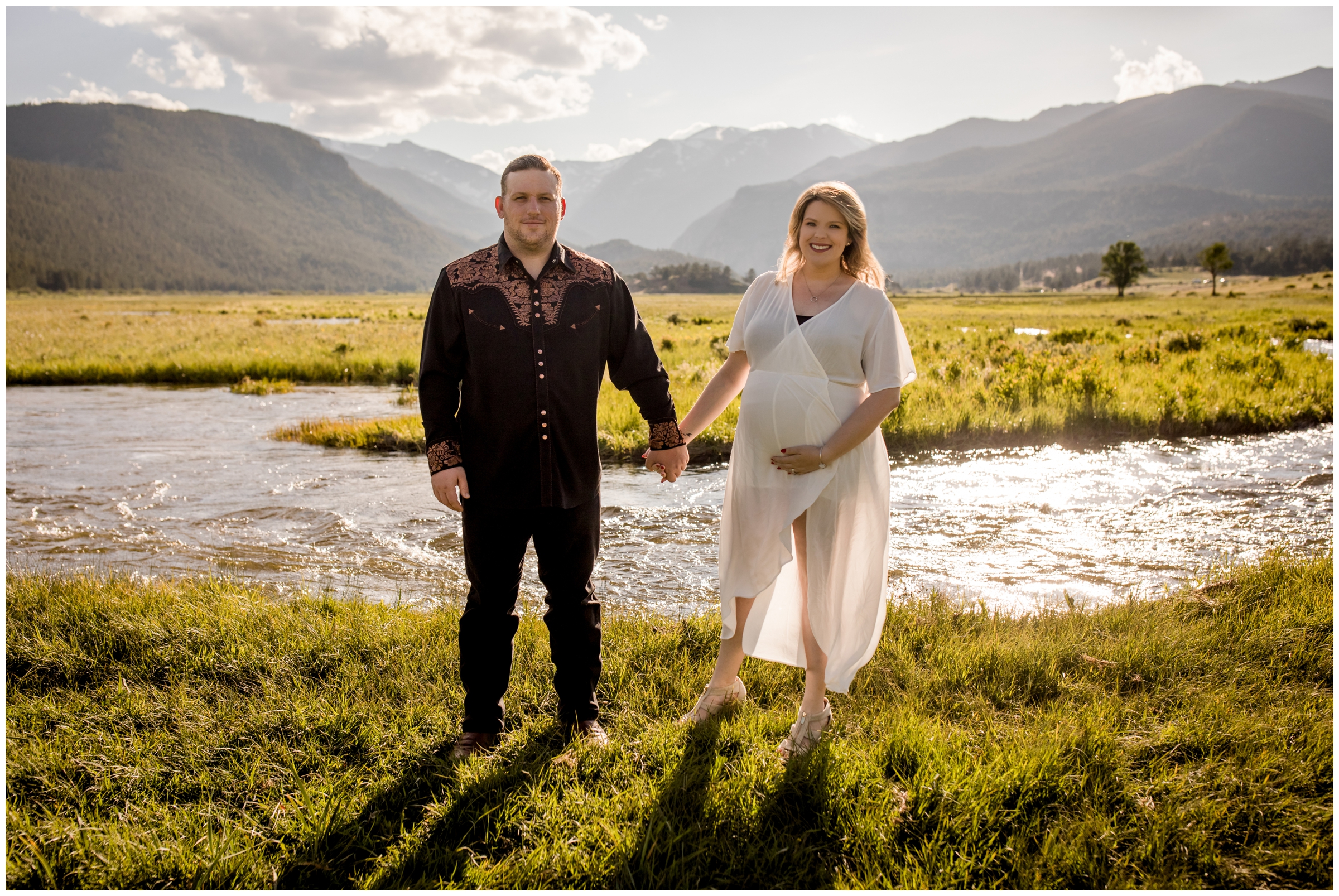 couple standing by a river during Estes Park Colorado maternity portraits 