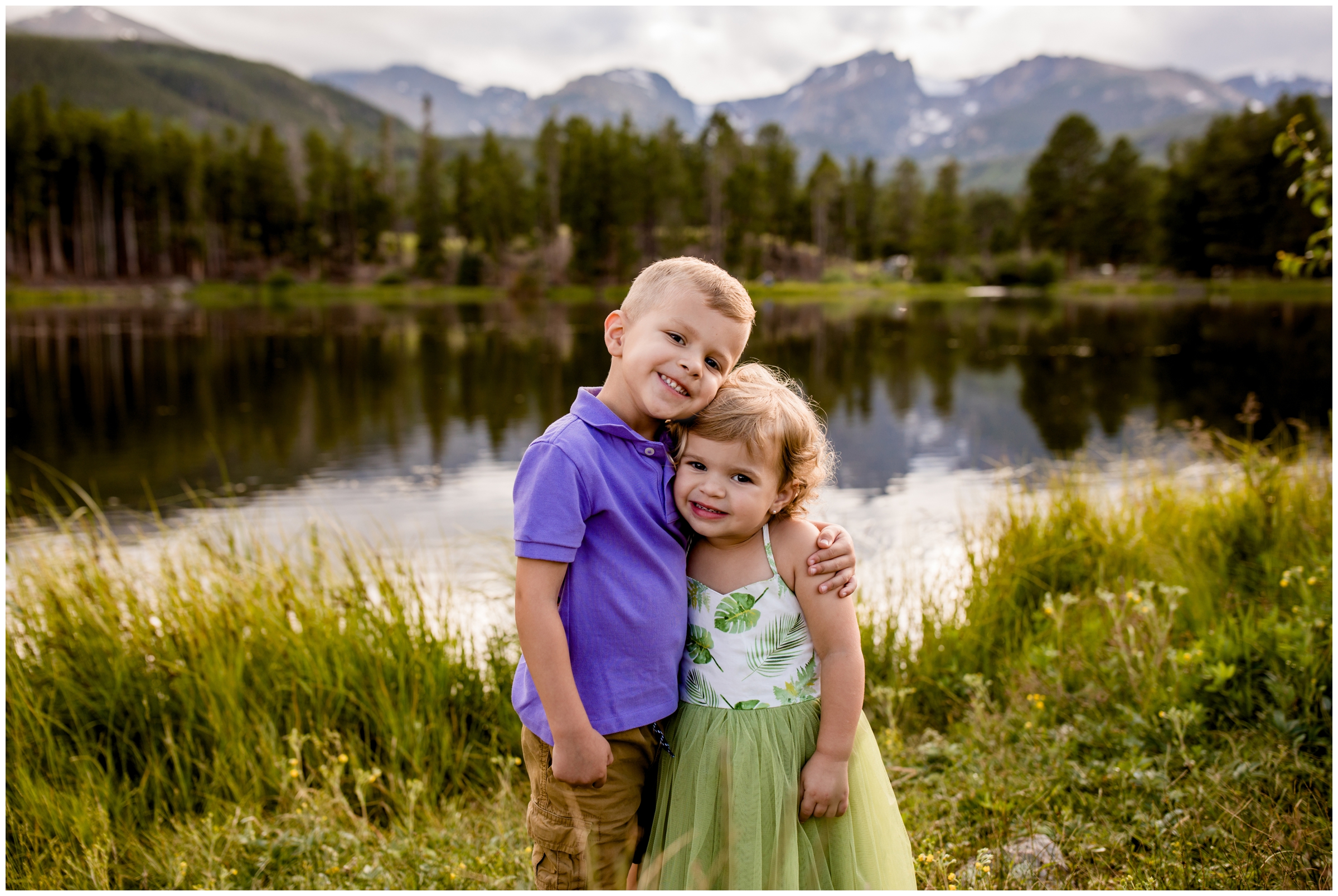kids hugging with sprague lake in background during estes park family portraits by Plum Pretty Photography