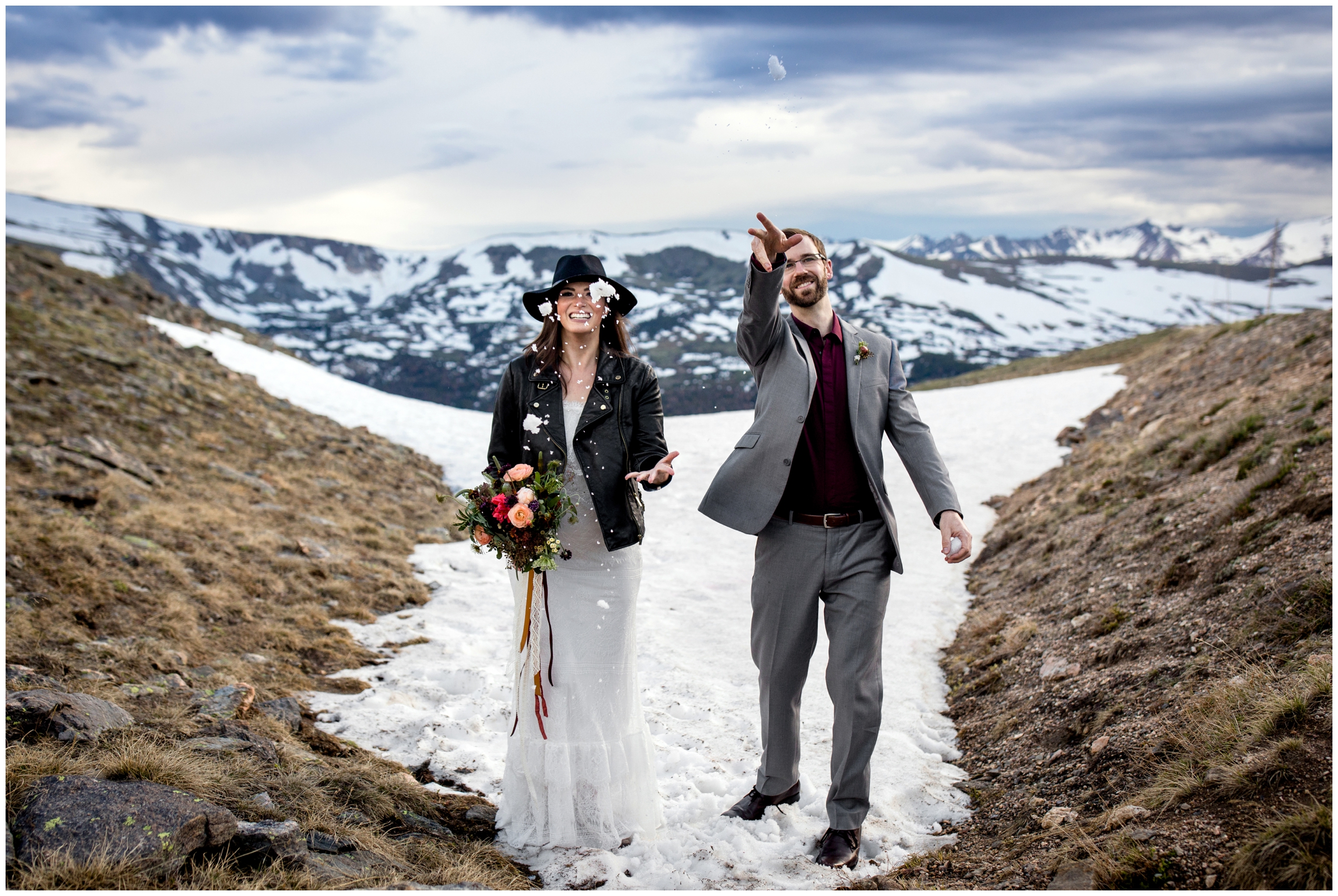 couple throwing snow during Estes Park Colorado mountain elopement photos 