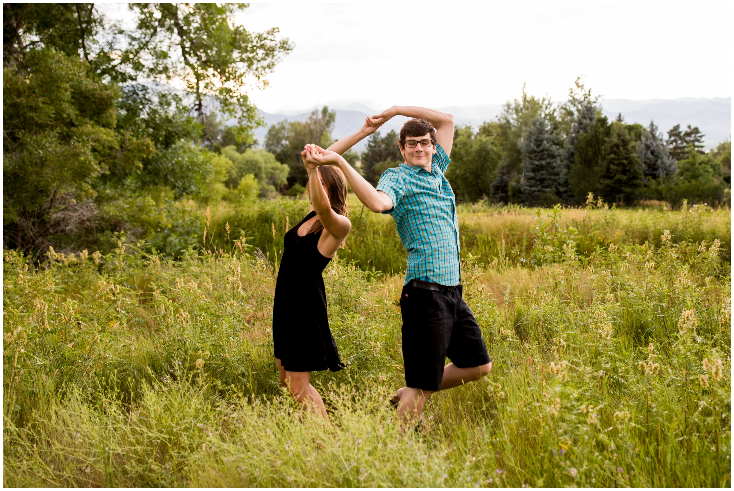 couple dancing in a field during Boulder Colorado summer engagement photos 