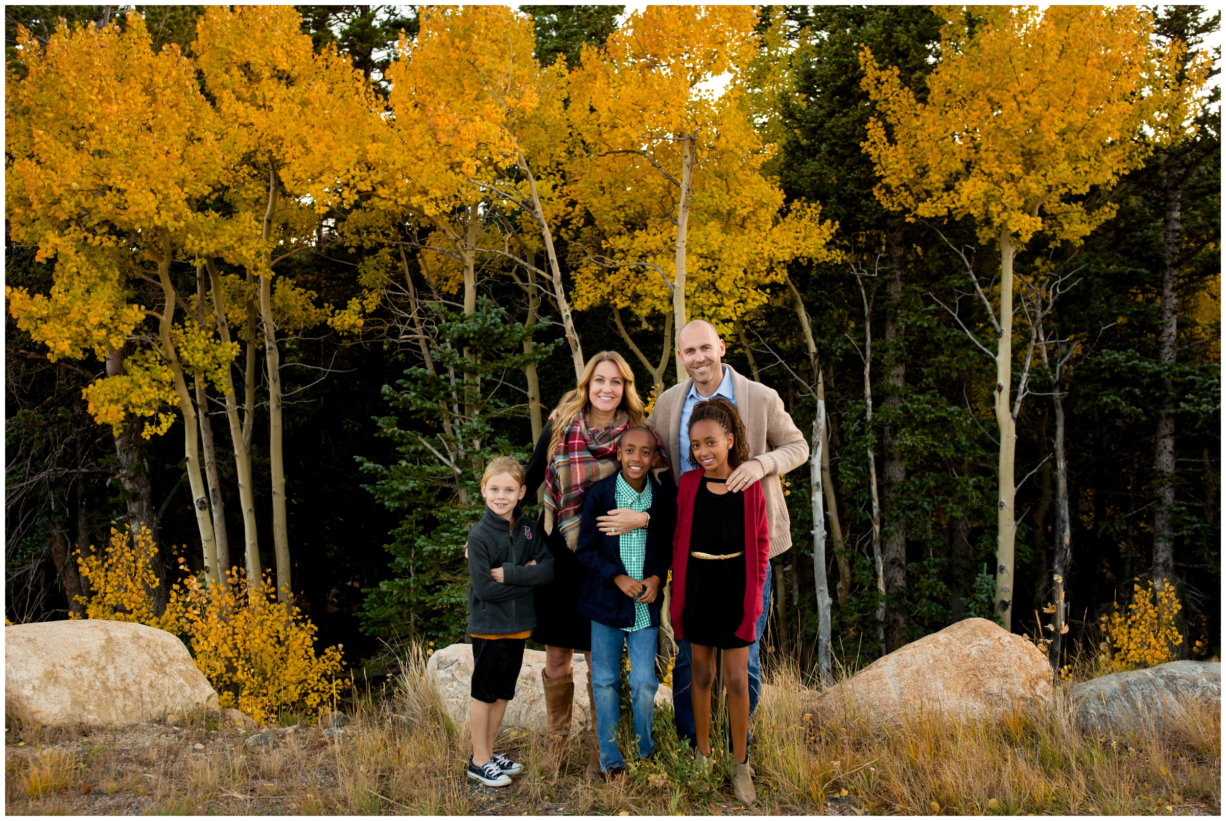 family posing with aspen trees in background during fall Colorado mountain family photos at Brainard Lake