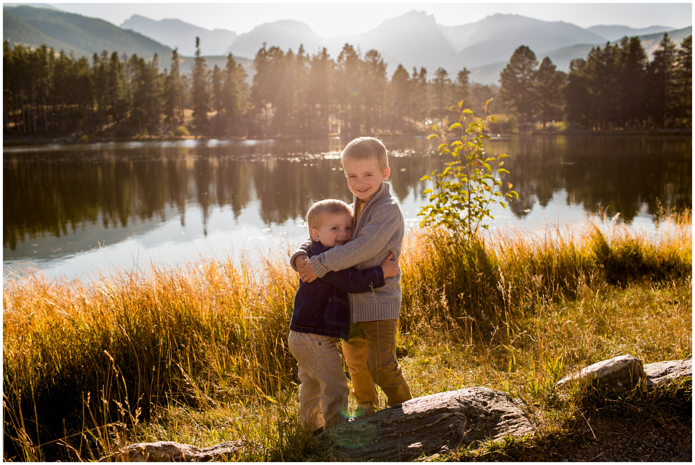little boys hugging with mountains in background at RMNP family photography session