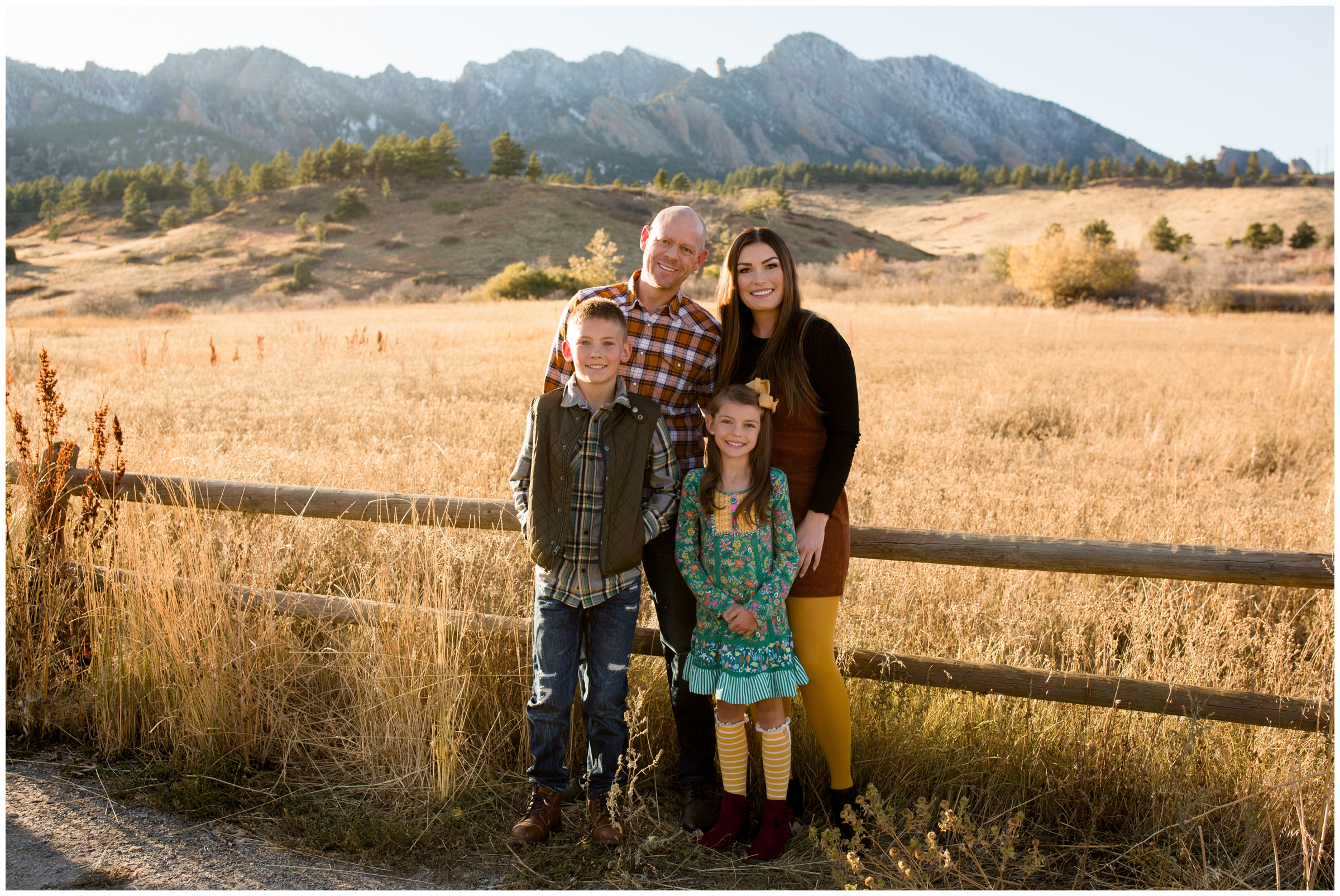 family posing with flatirons in background during Boulder family photography session 