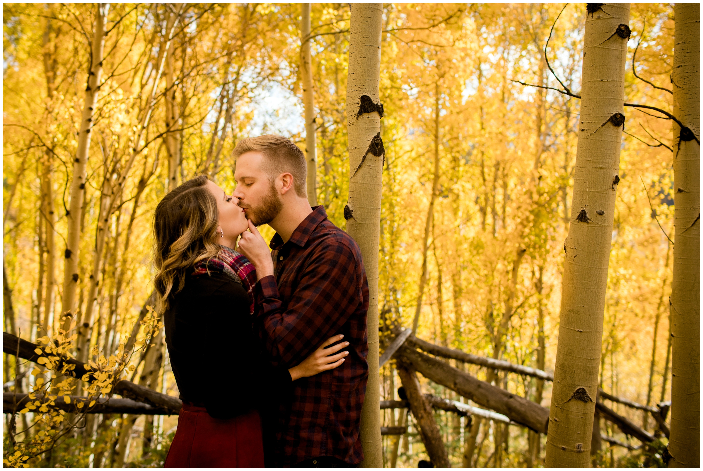 couple kissing in aspen grove during Breckenridge Colorado fall engagement pictures 