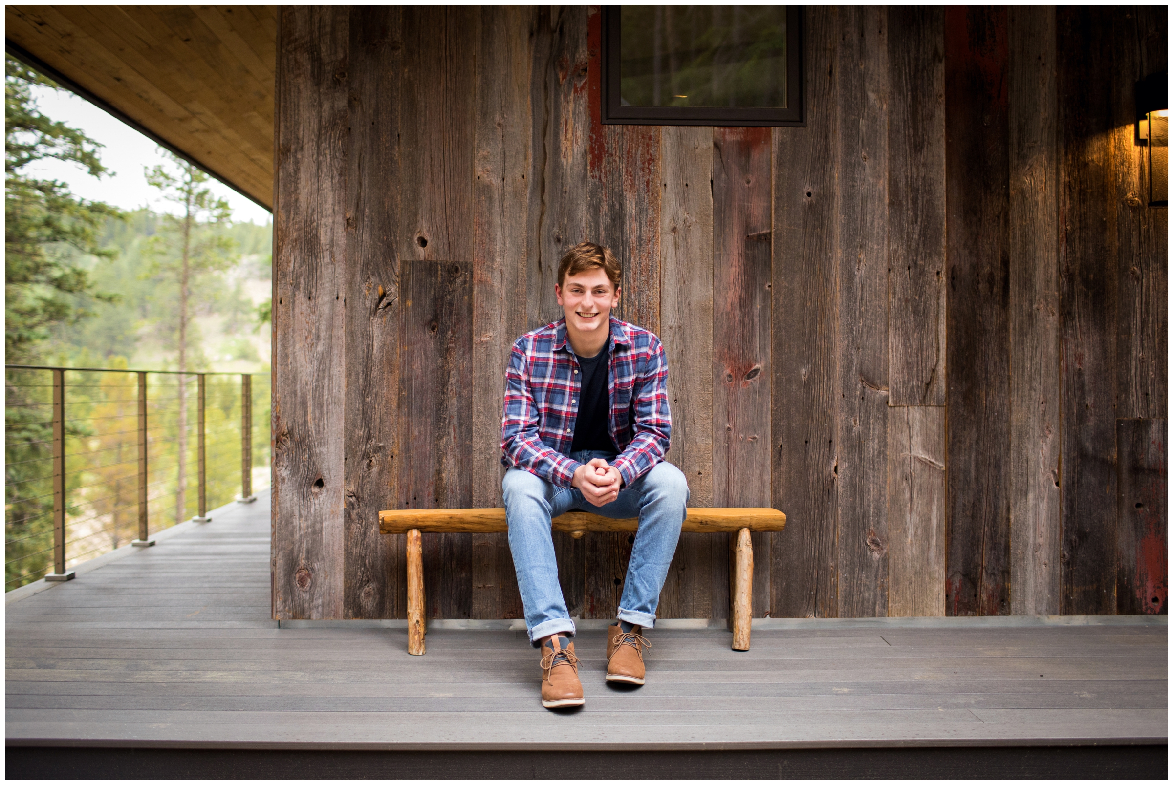 teen boy sitting on bench at rustic cabin during Colorado portraits