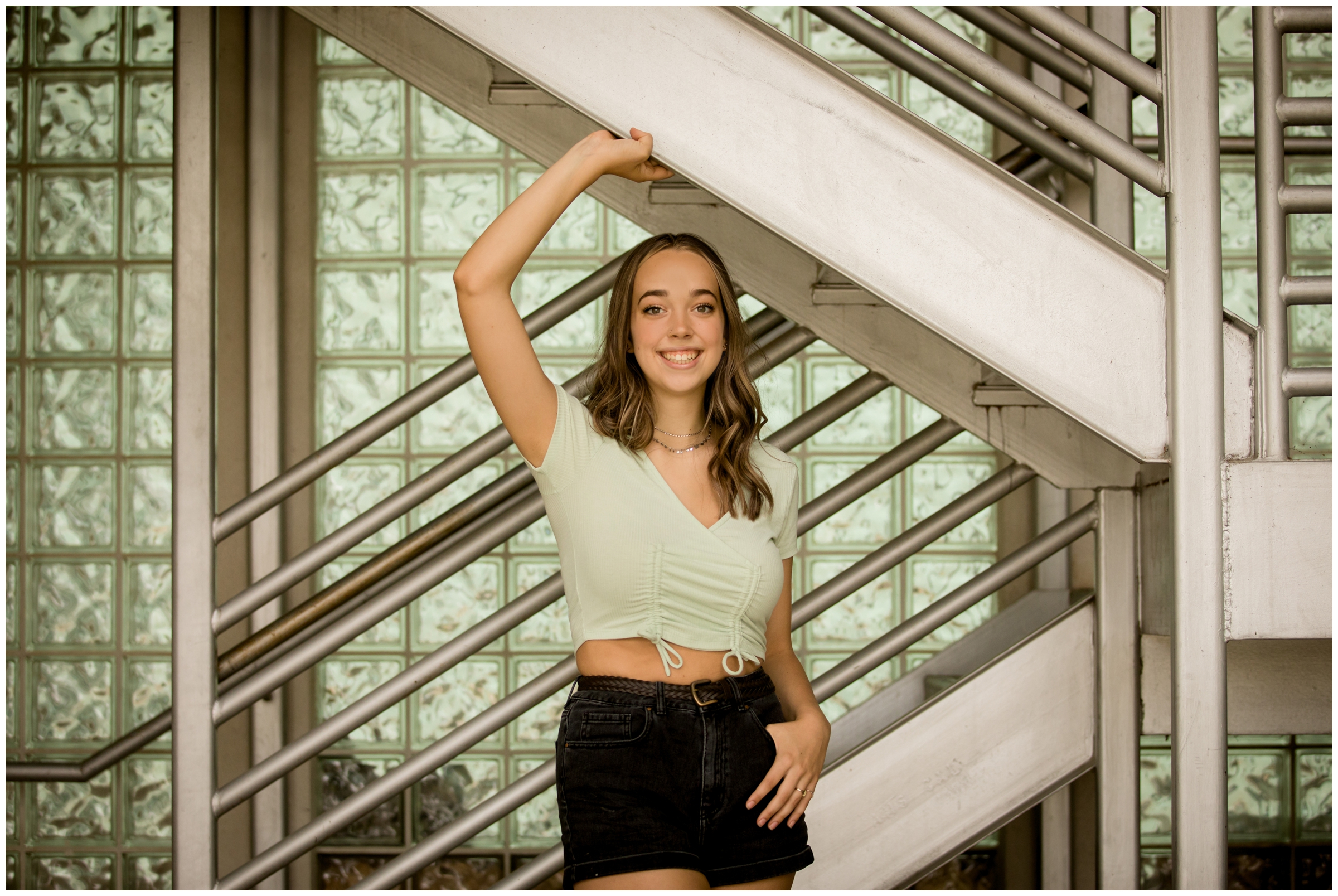 teen posing in stairwell during urban Colorado senior photography session 