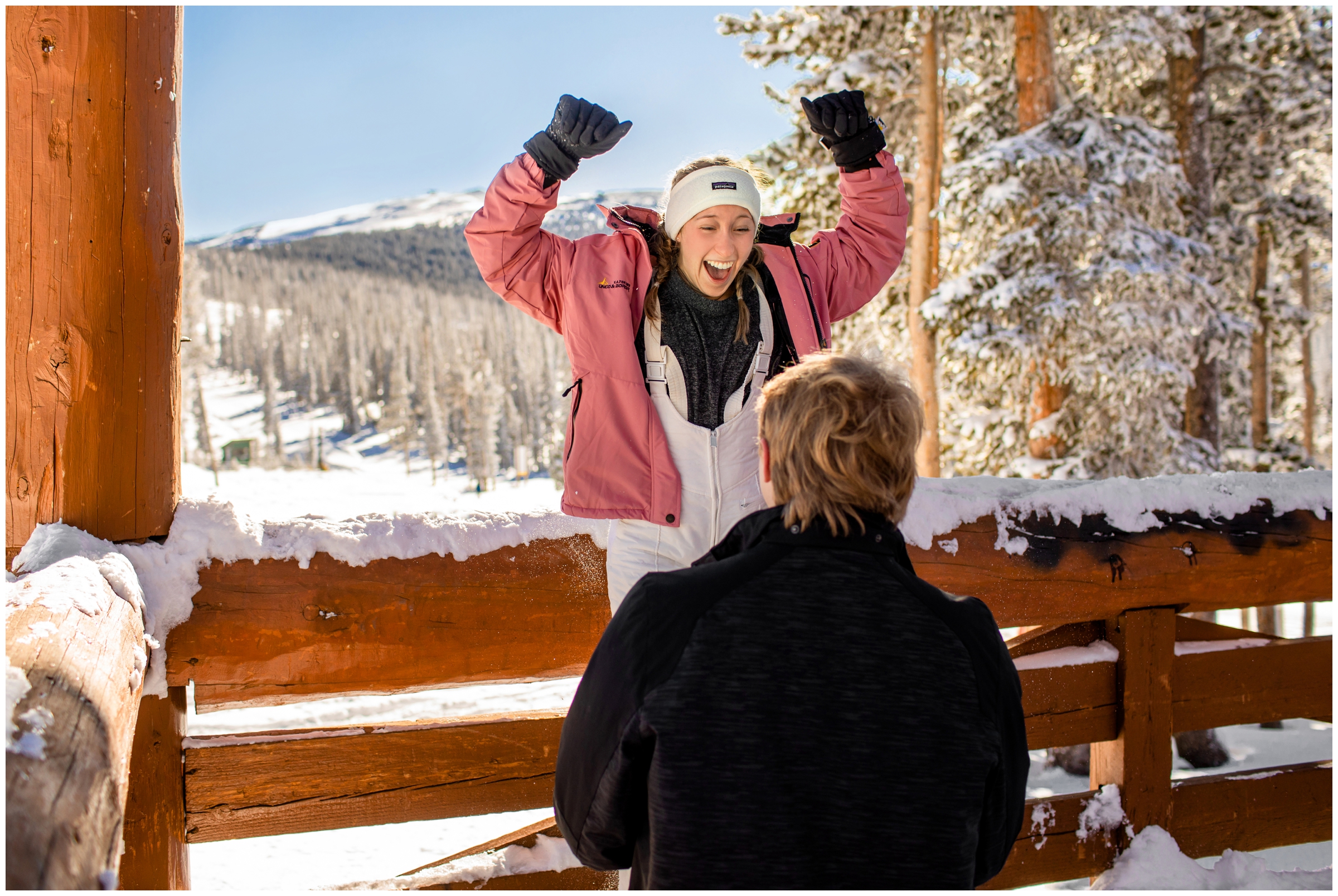 woman celebrating during Colorado ski proposal photos at Sunspot by Winter Park engagement photographer Plum Pretty Photography