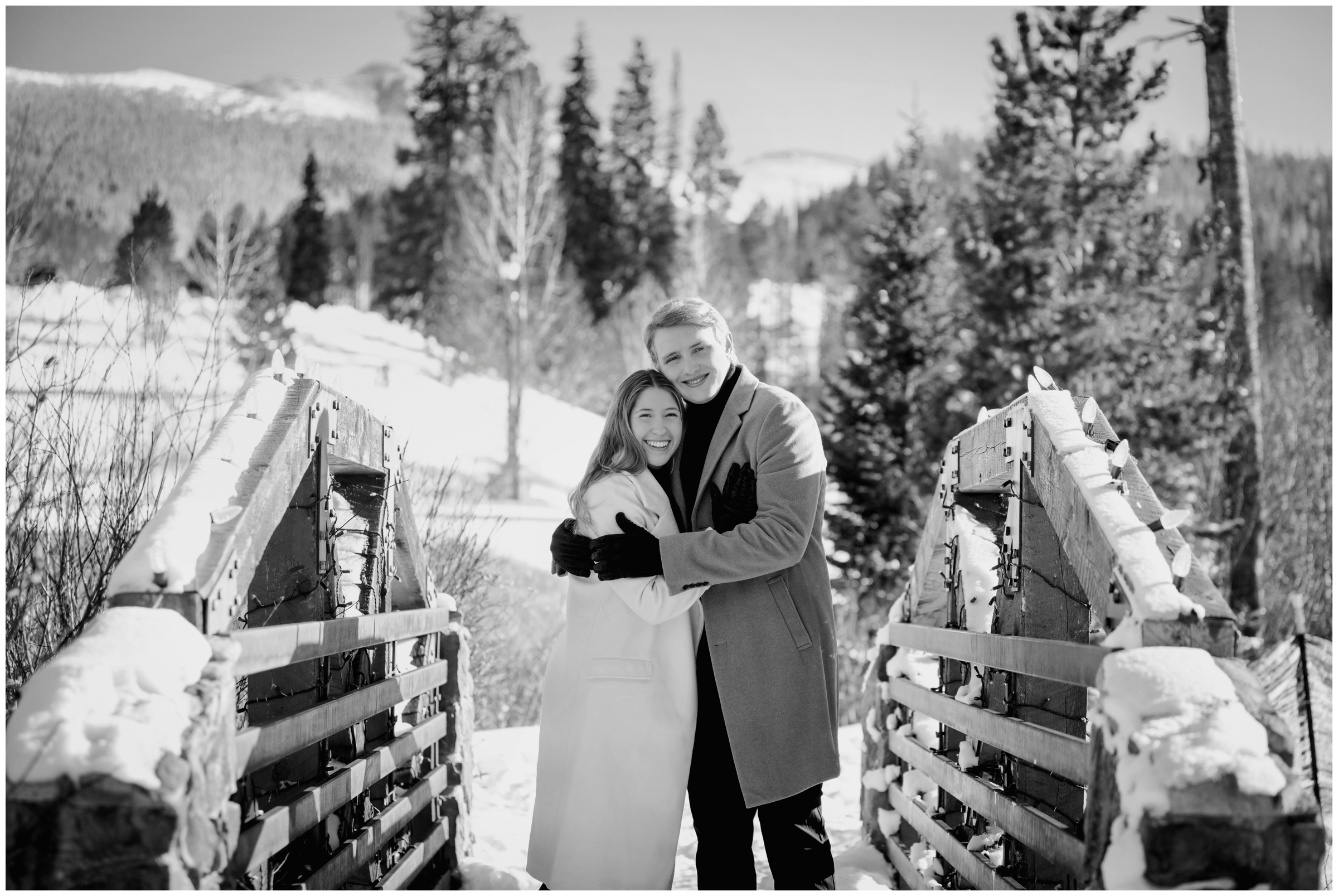 couple hugging on bridge during winter engagement pictures in the Colorado mountains 
