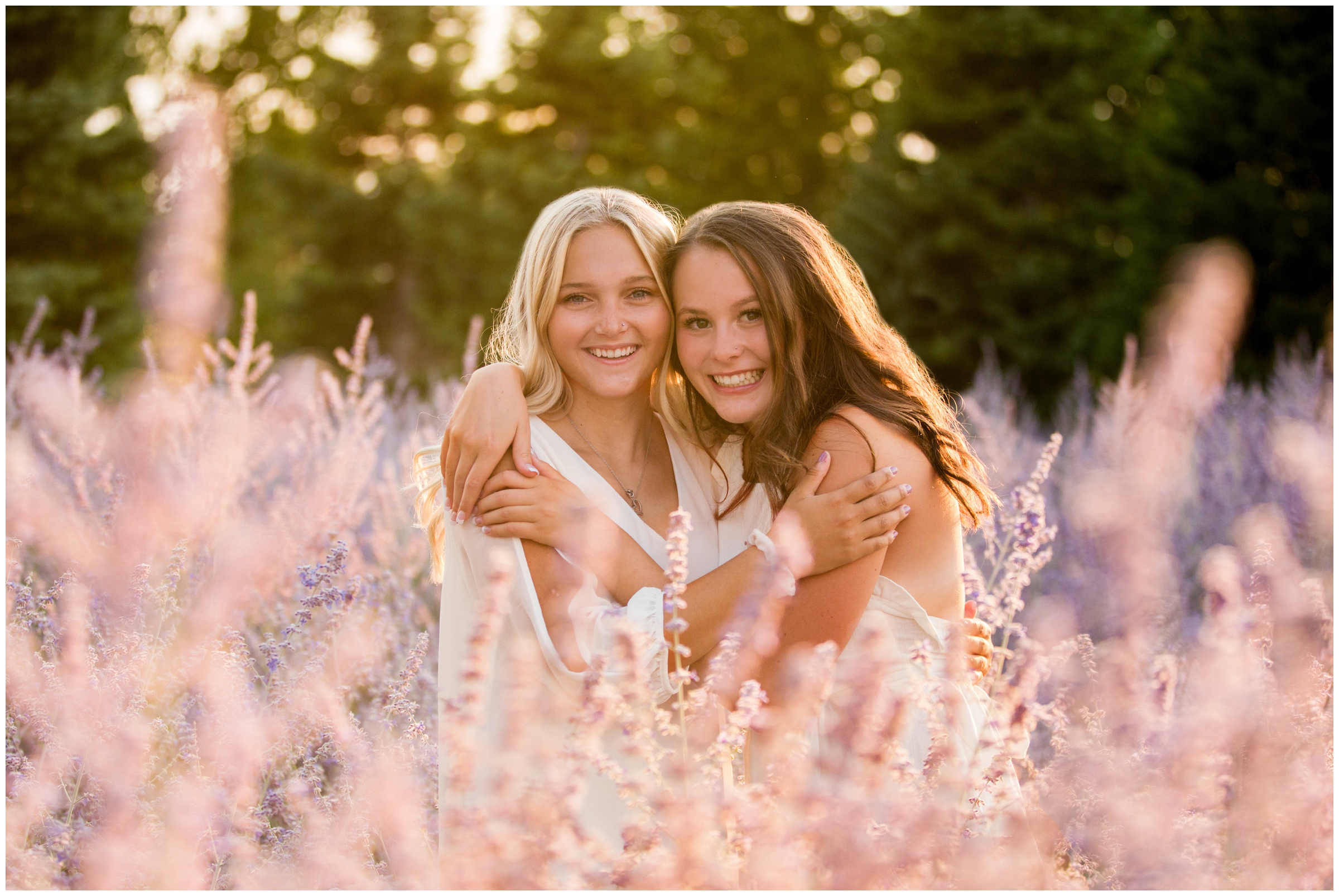 teen girls hugging in flower field during best friend senior pictures