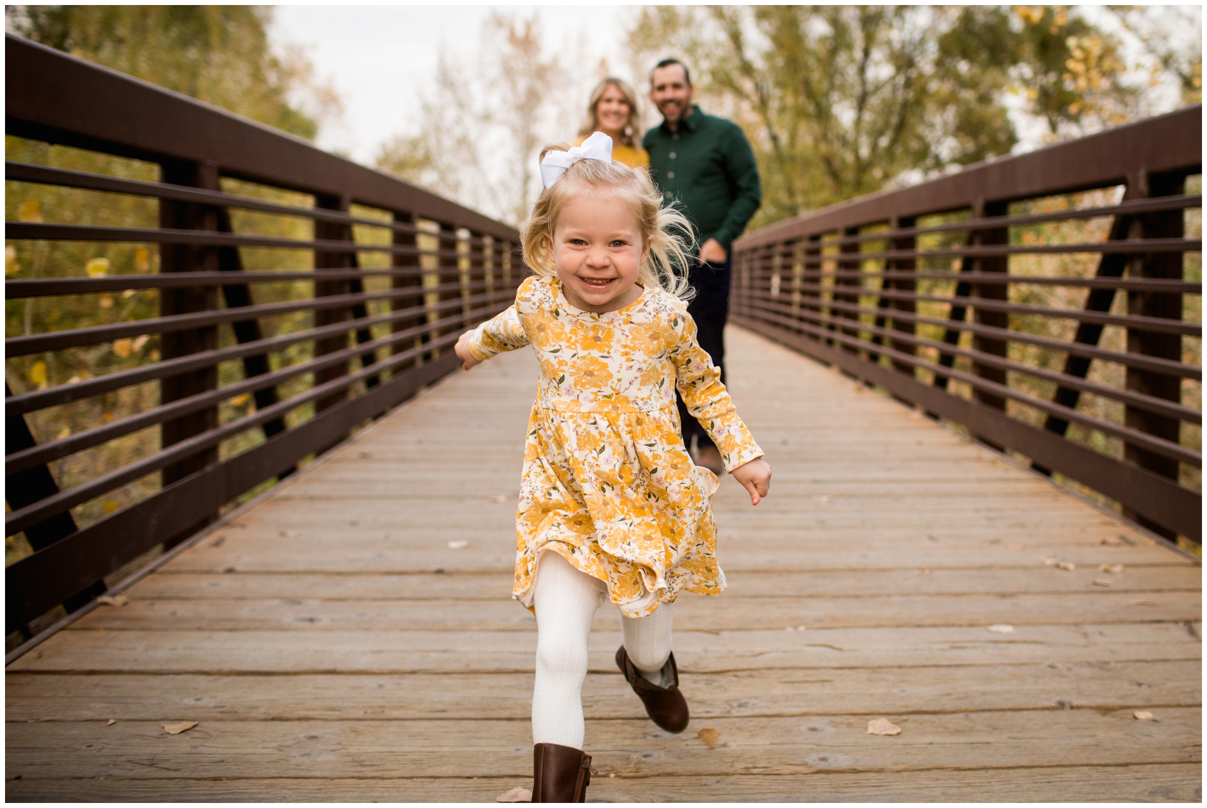 little girl running on bridge during Longmont Colorado family pictures by plum pretty photography