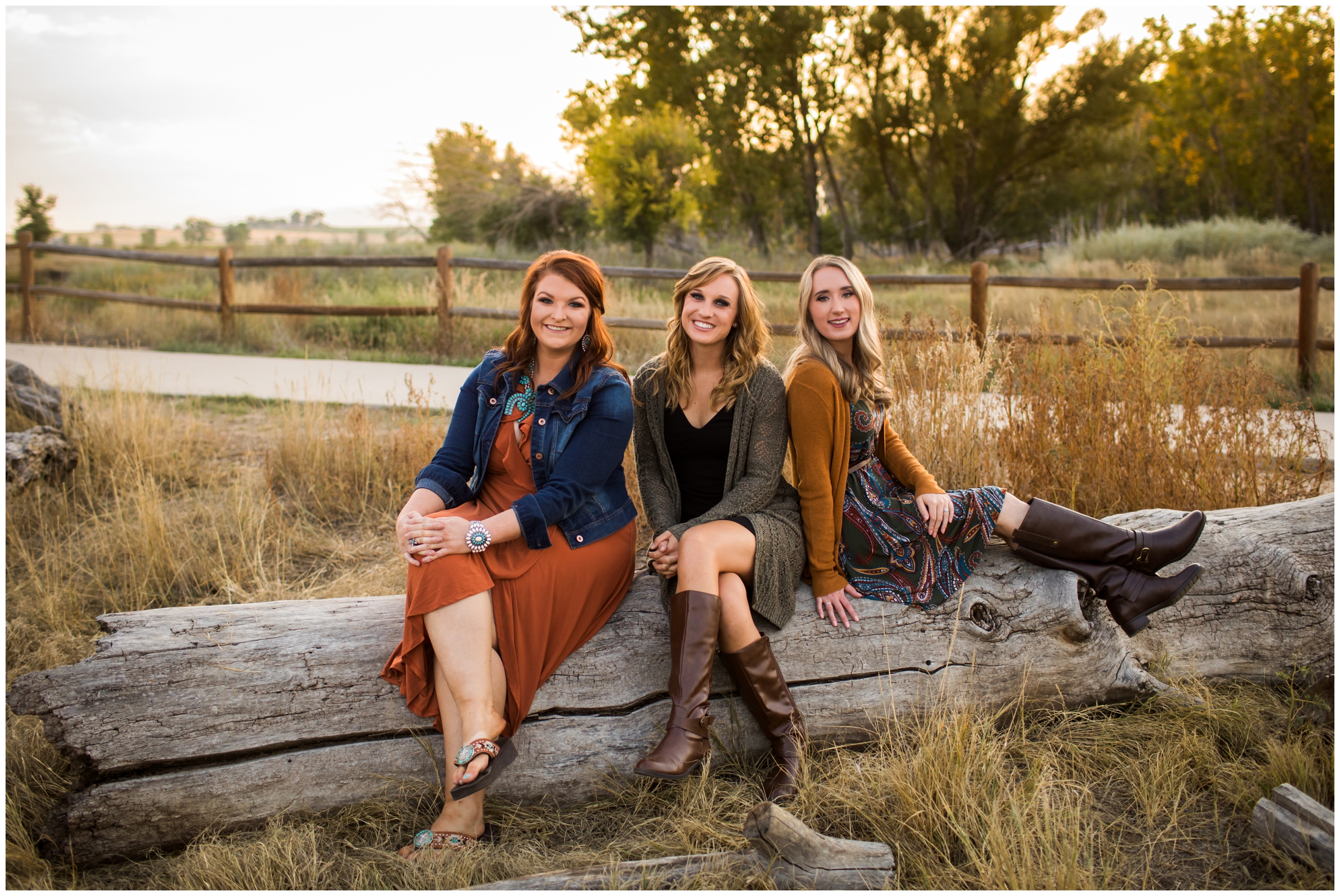 three women sitting on tree log during best friends photography session in Longmont Colorado