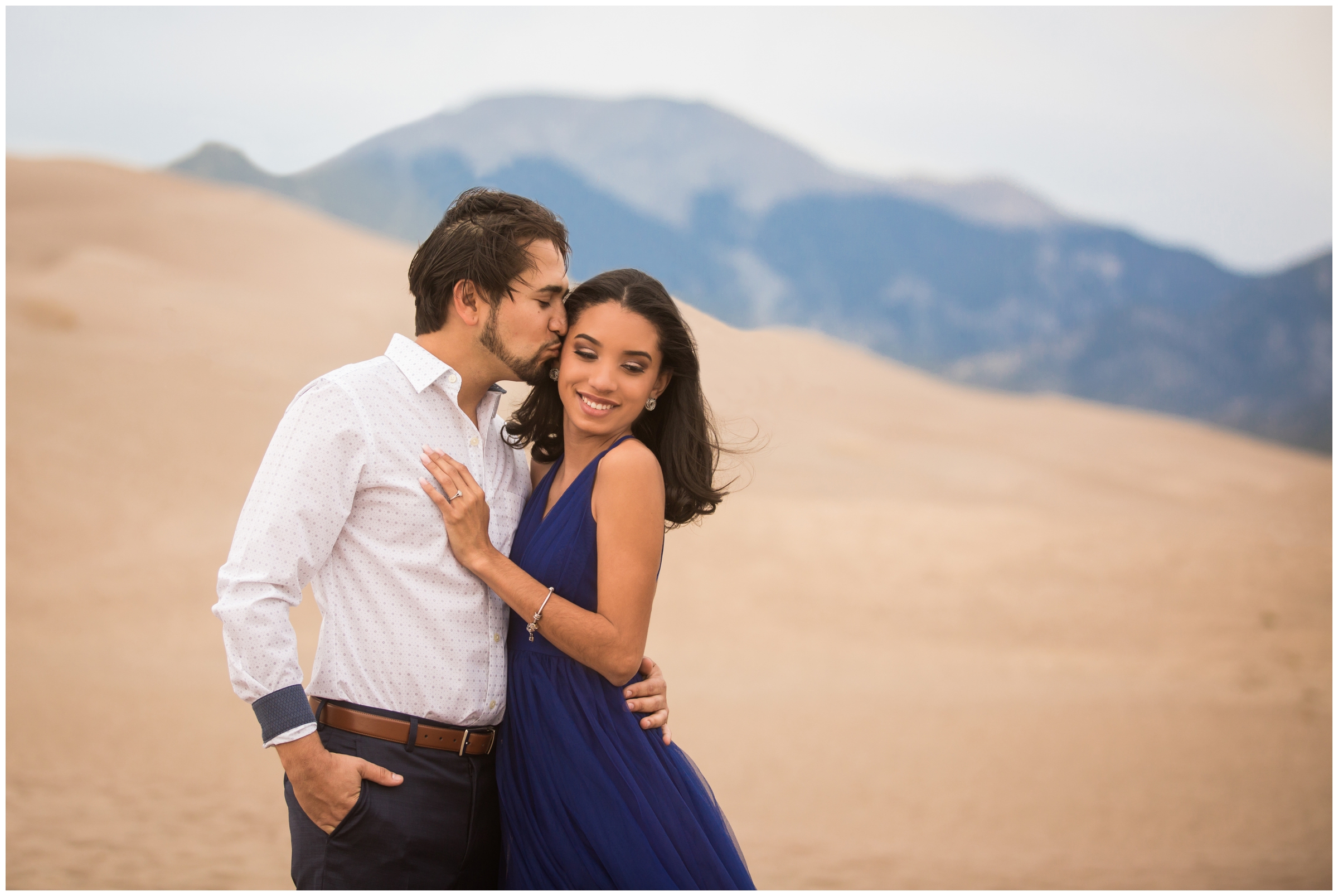 couple kissing during Colorado engagement portraits at Great Sand Dunes 