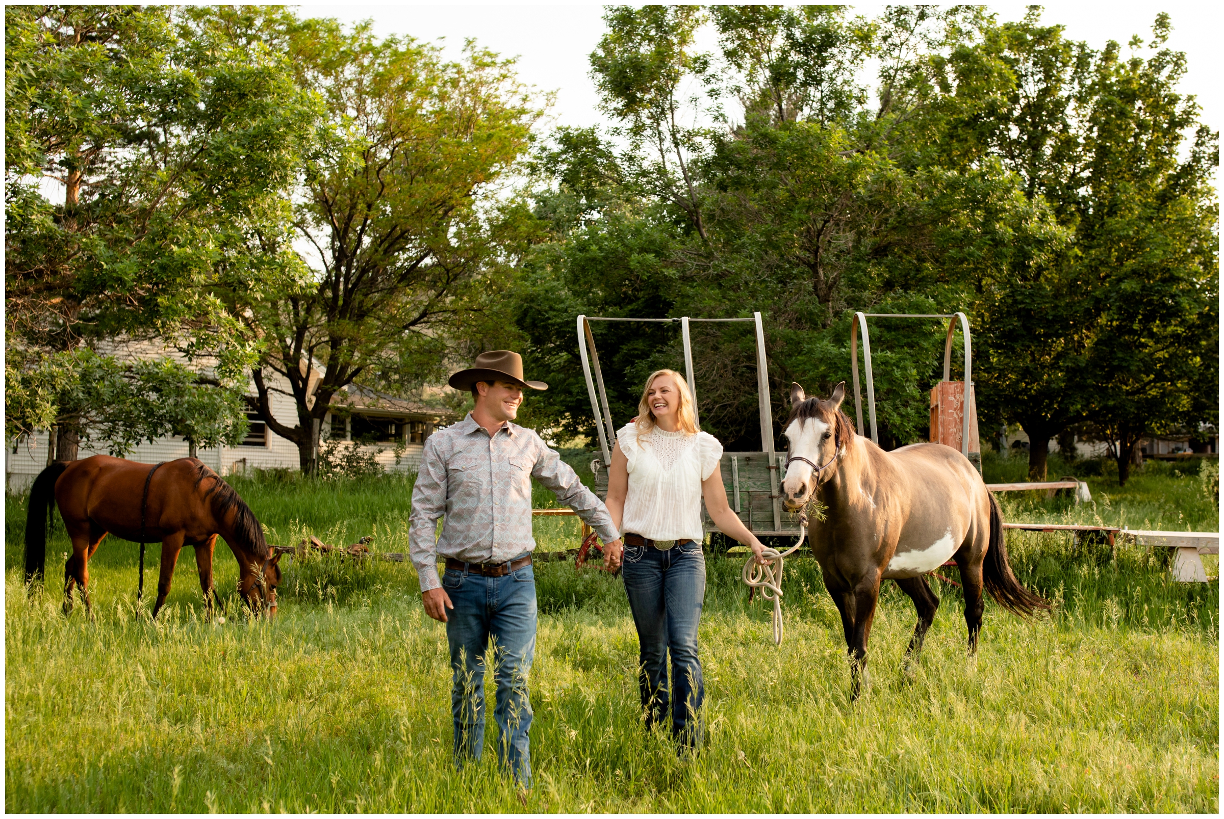 Couple walking with horses during Colorado engagement photography session in Loveland 