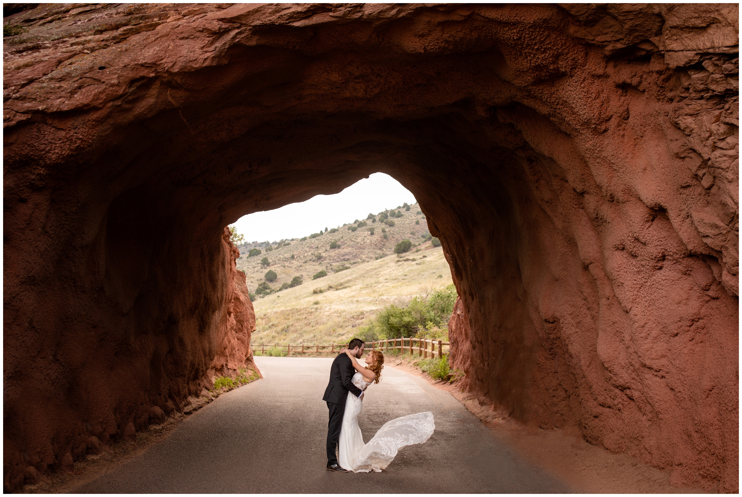 bride and groom kissing in the tunnel at Red Rocks during Solterra Colorado wedding photos by Plum Pretty Photography