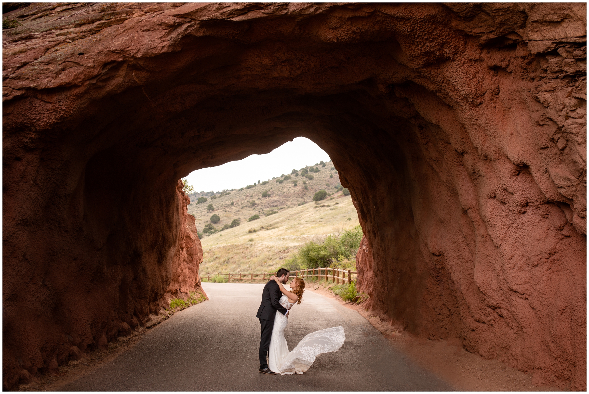 bride and groom kissing in the tunnel at Red Rocks during Solterra Colorado wedding photos by Plum Pretty Photography 