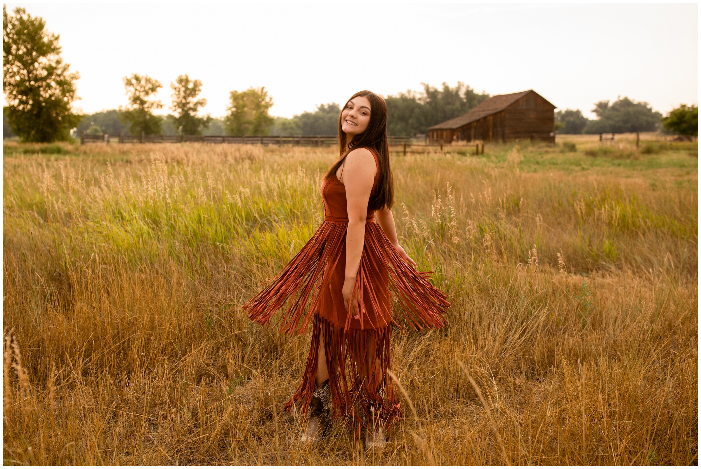 teen spinning in fringe dress during rustic Longmont Colorado senior photography session at Sandstone Ranch