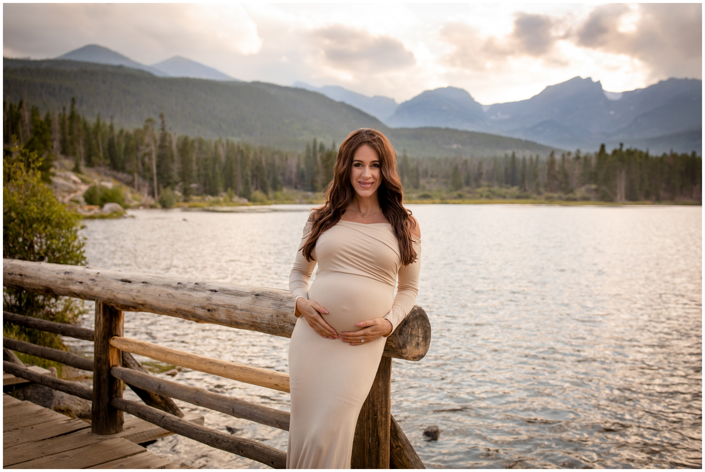 pregnant woman leaning on wooden bridge during Sprague Lake RMNP maternity portraits in Estes Park Colorado 
