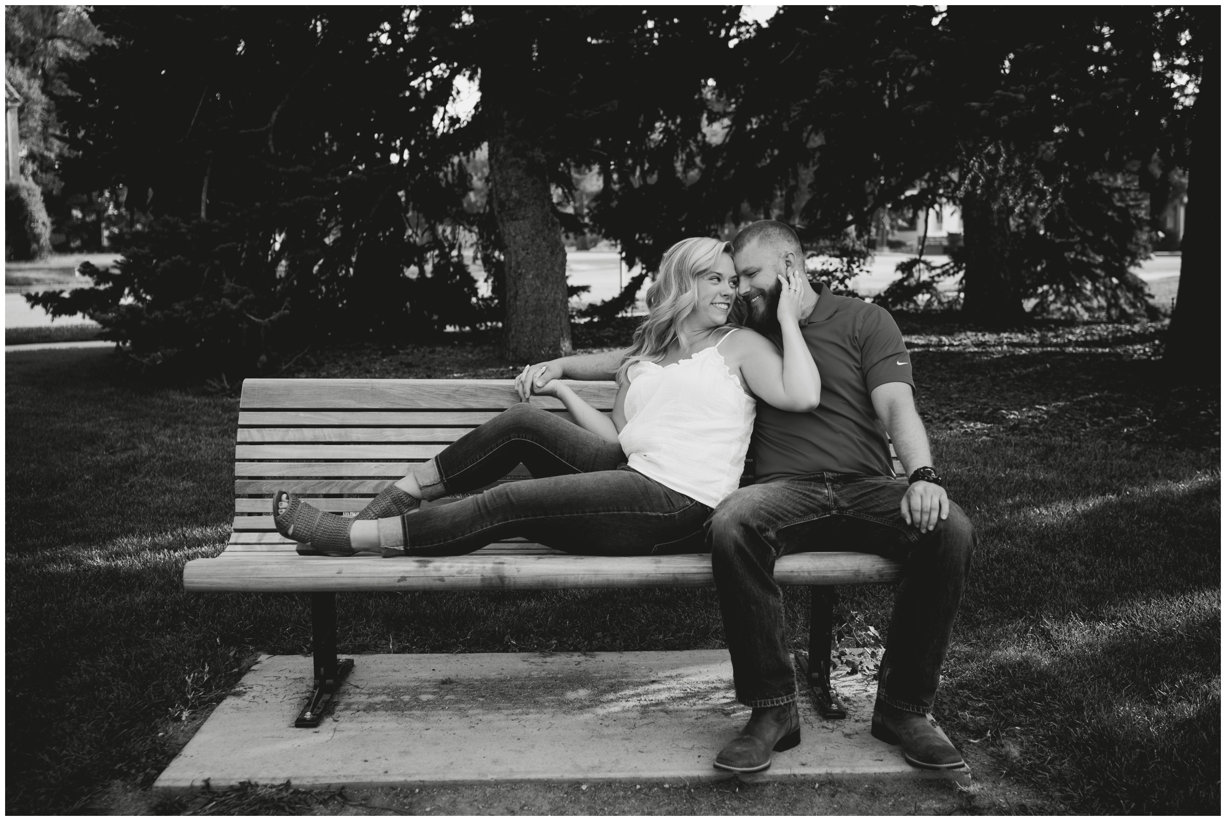 couple cuddling on bench during northern Colorado engagement photos