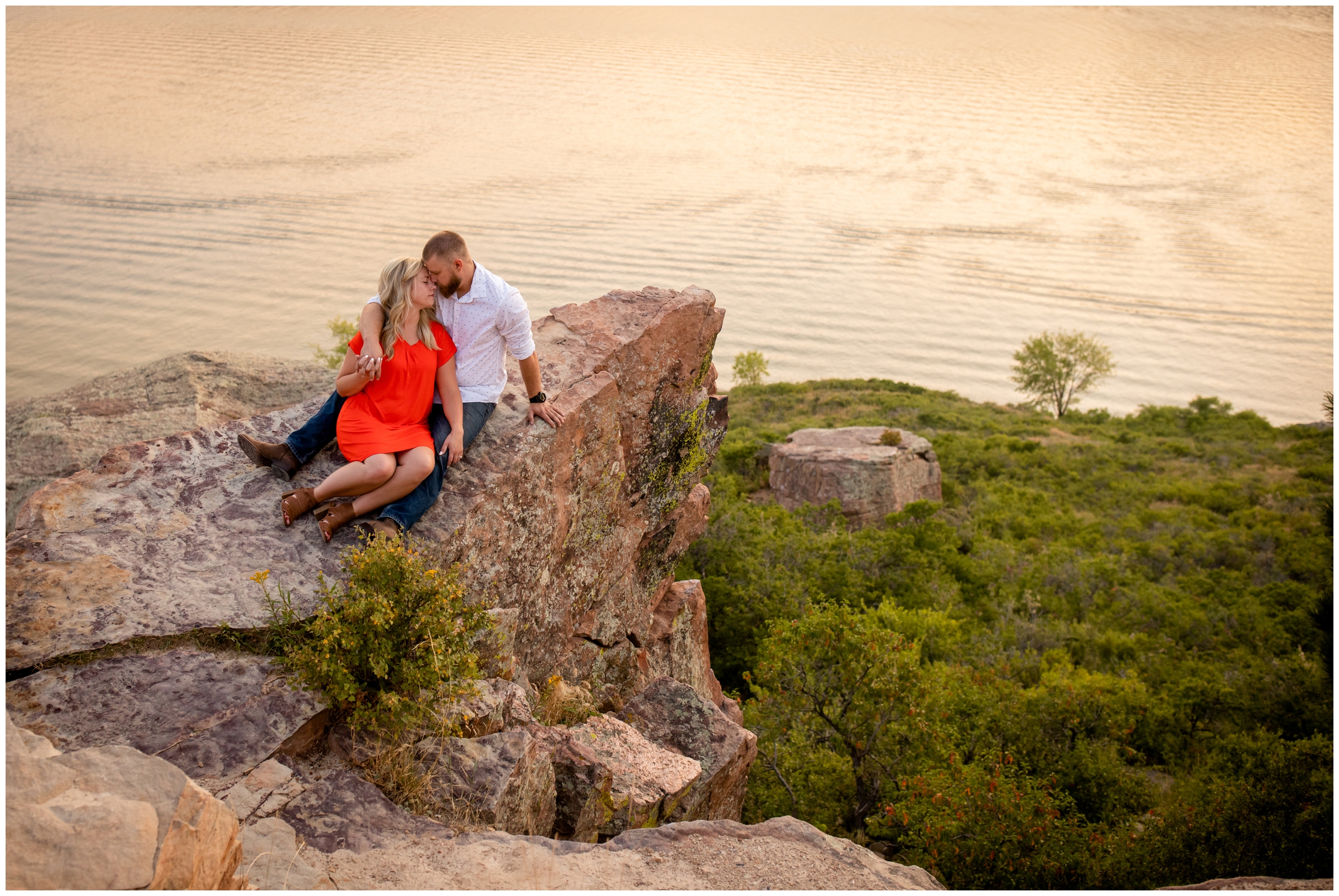 couple cuddling on cliff during Horsetooth Reservoir Colorado engagement pictures 