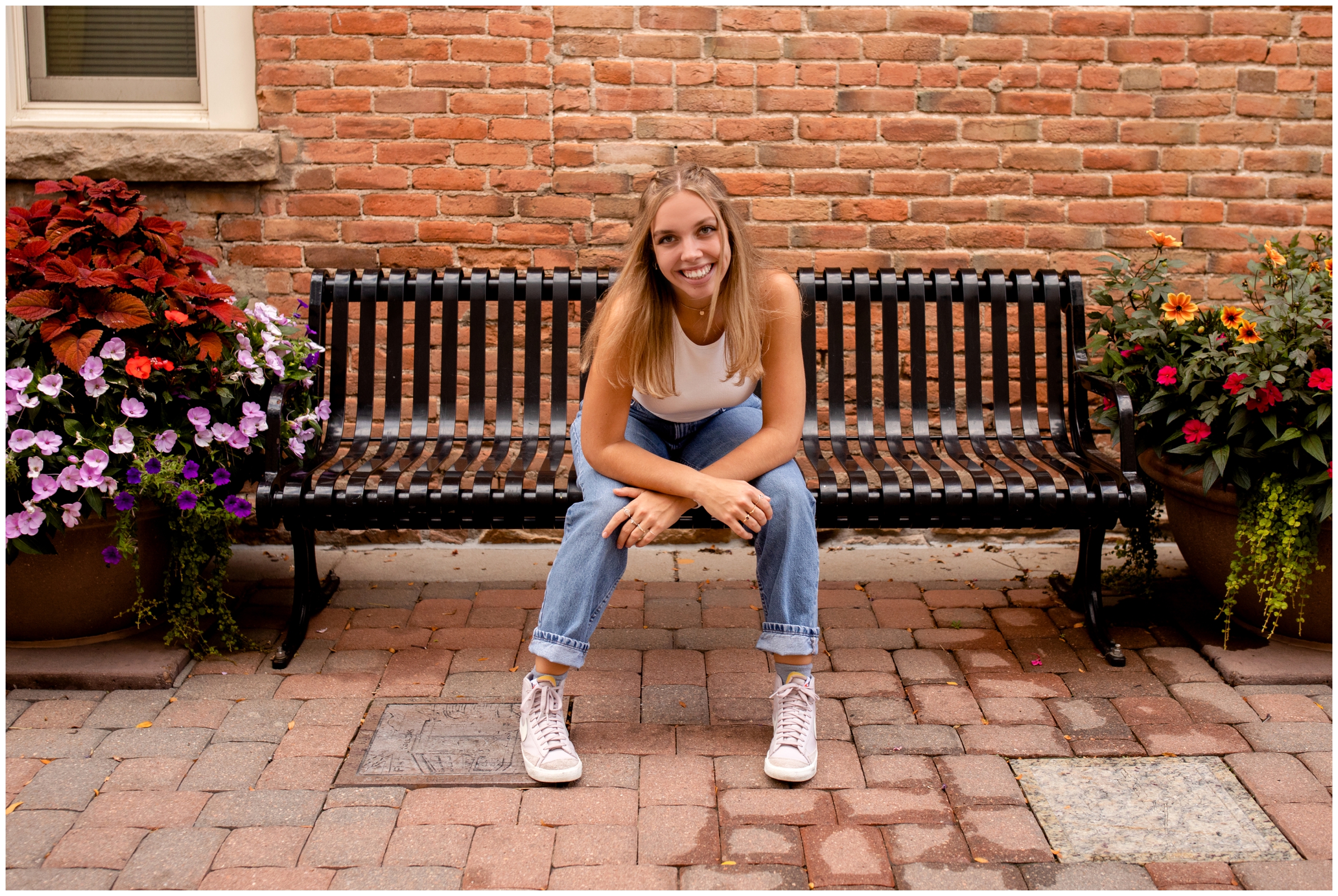 teen sitting on a bench during urban Colorado senior photography session 