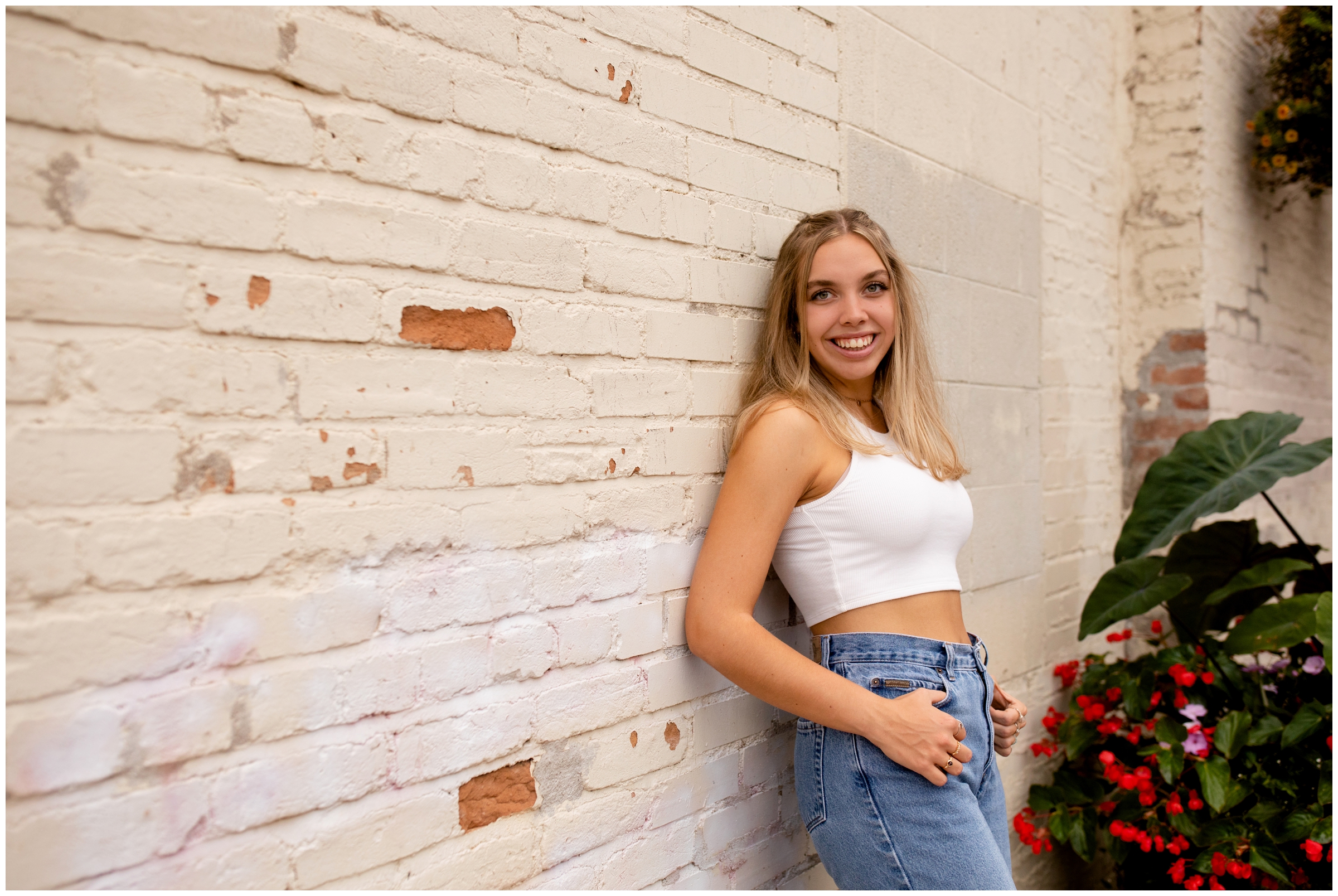 teen leaning against brick wall during Old Firehouse Alley Fort Collins senior pictures 