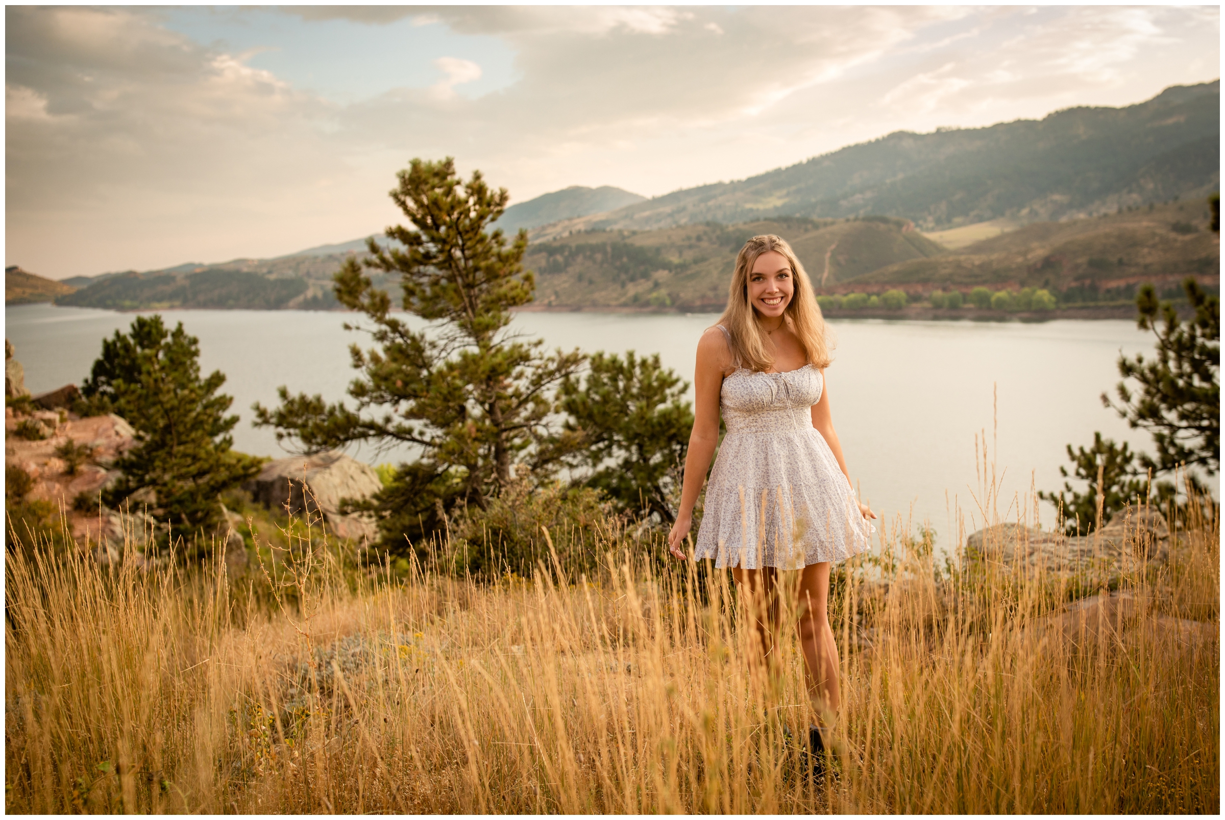 teen girl spinning in a field of long grass during Horestooth Reservoir Fort Collins senior pictures 