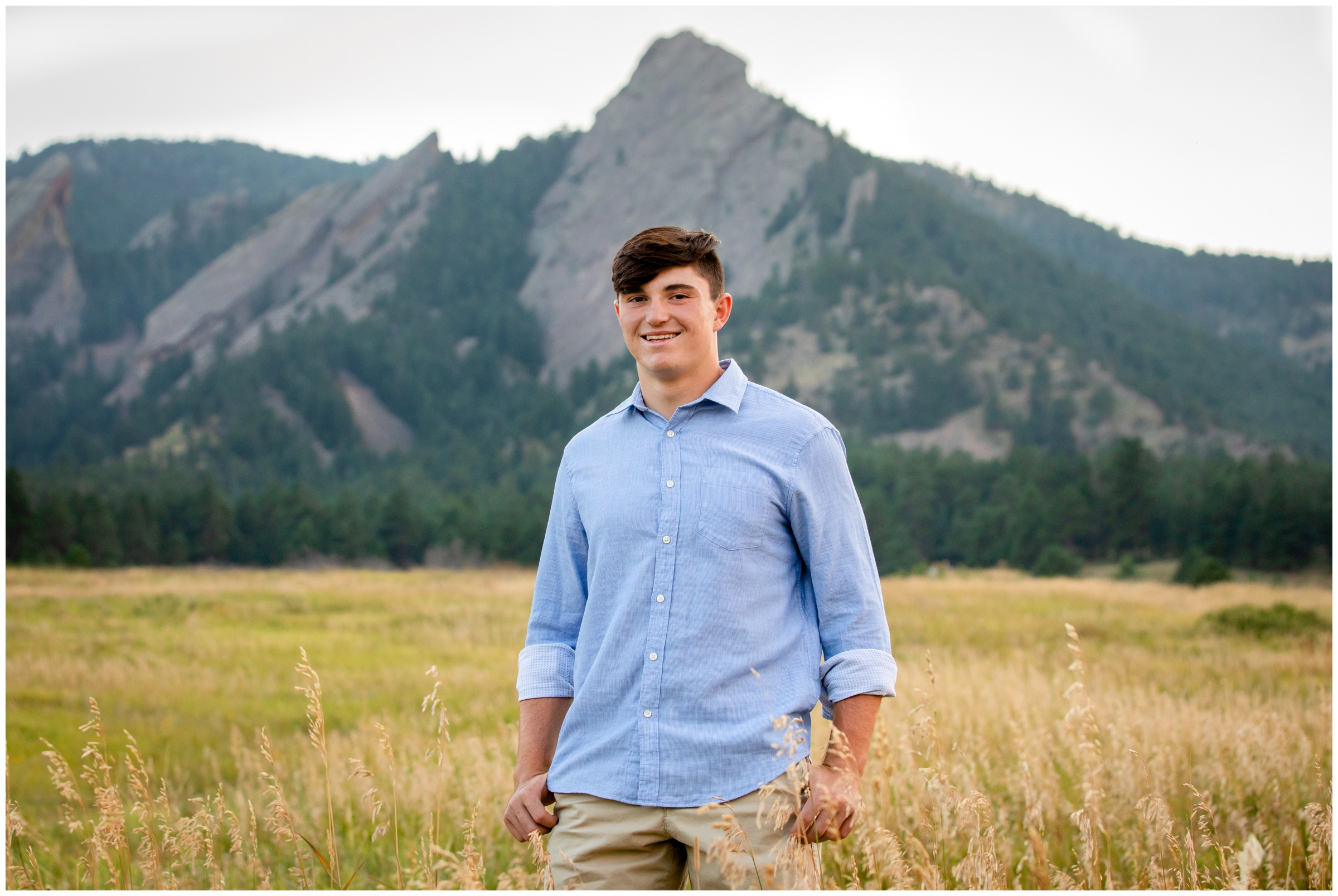 Holy Family high school student posing in a field at Chautauqua Park during Boulder senior photos 