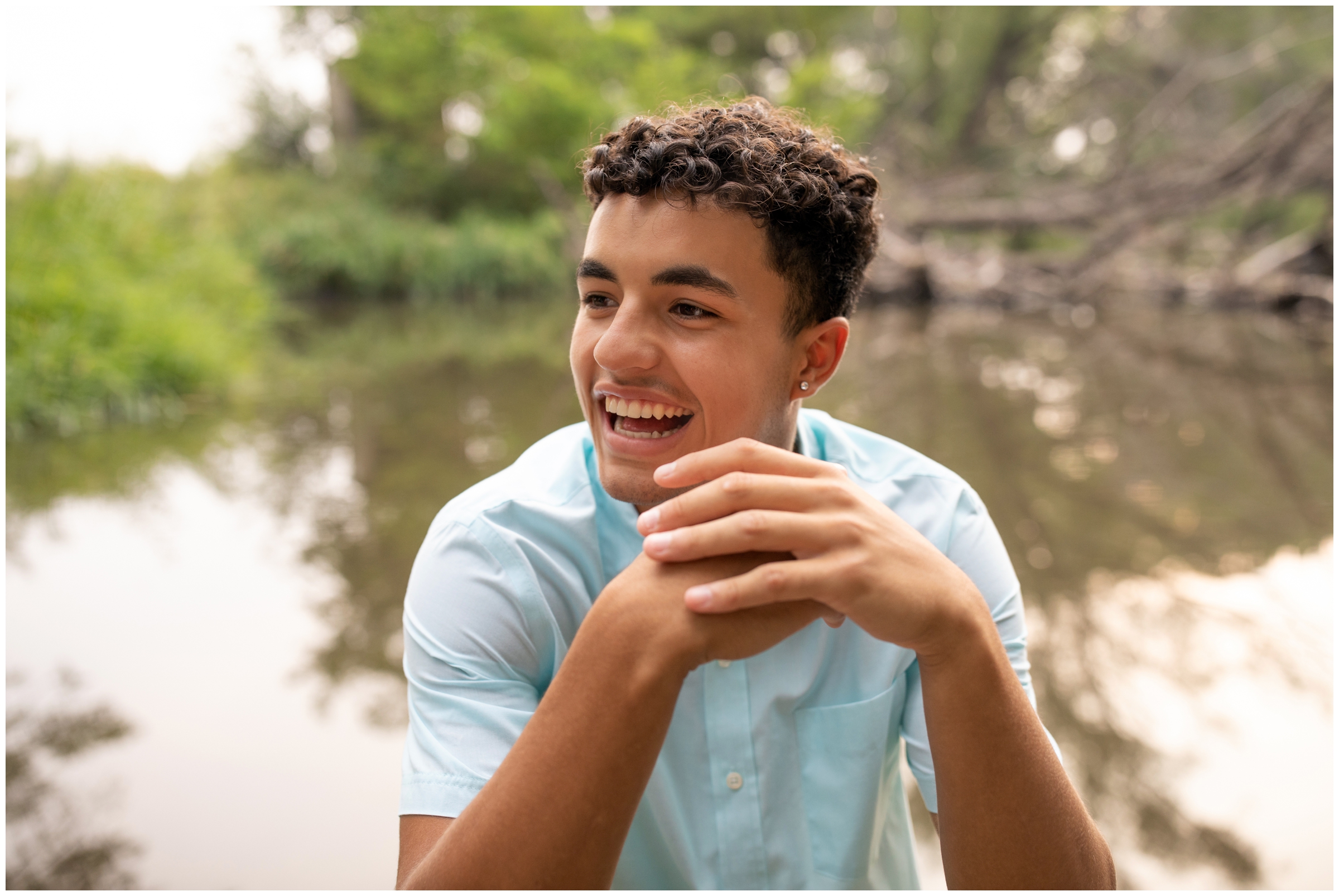 teen boy candidly laughing during lake senior photos in Longmont CO 
