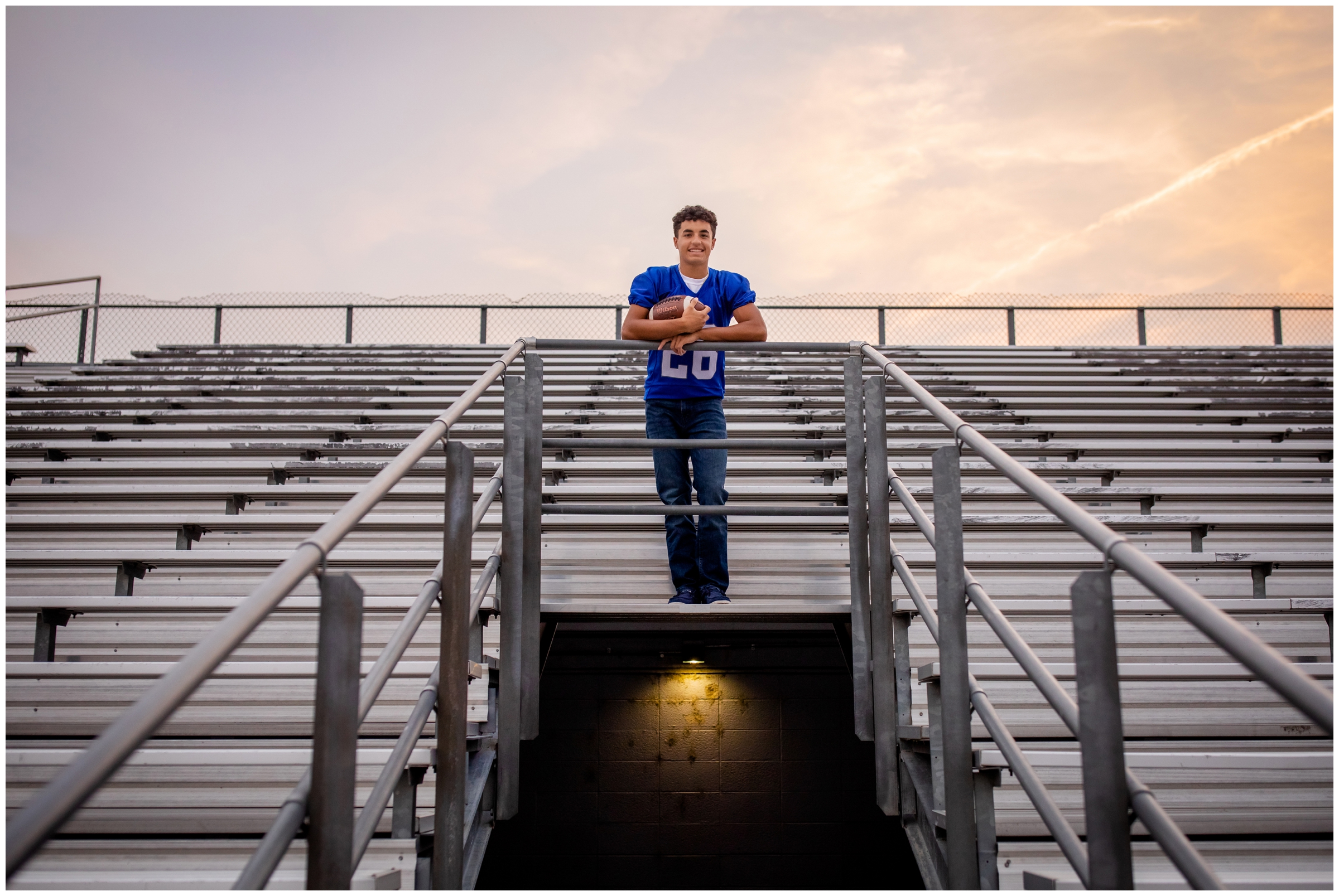 football player posing on the bleachers at longmont high school during Colorado senior photography session 