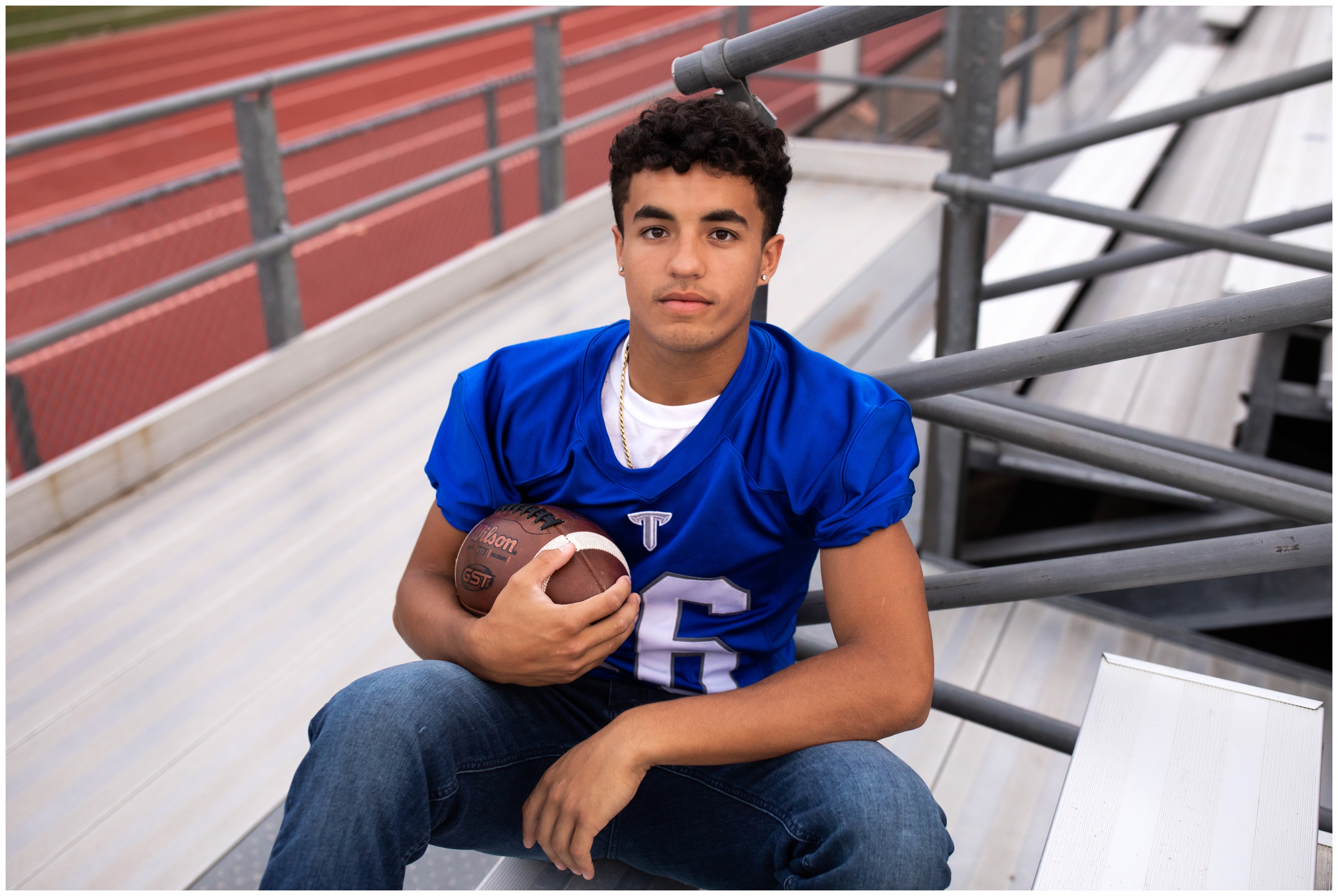 football player sitting on the bleachers during Longmont High school football senior photos in Colorado 