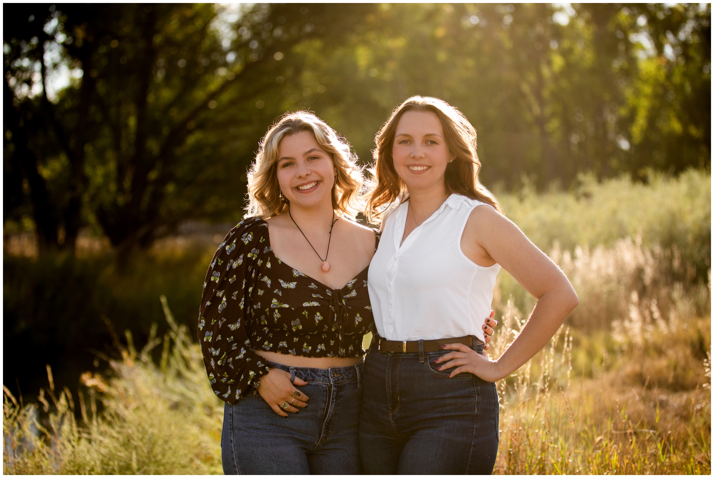 sisters posing in a field at sandstone ranch in northern Colorado 
